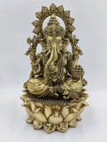 Large brass statue of Ganesh seated on detailed lotus flower base