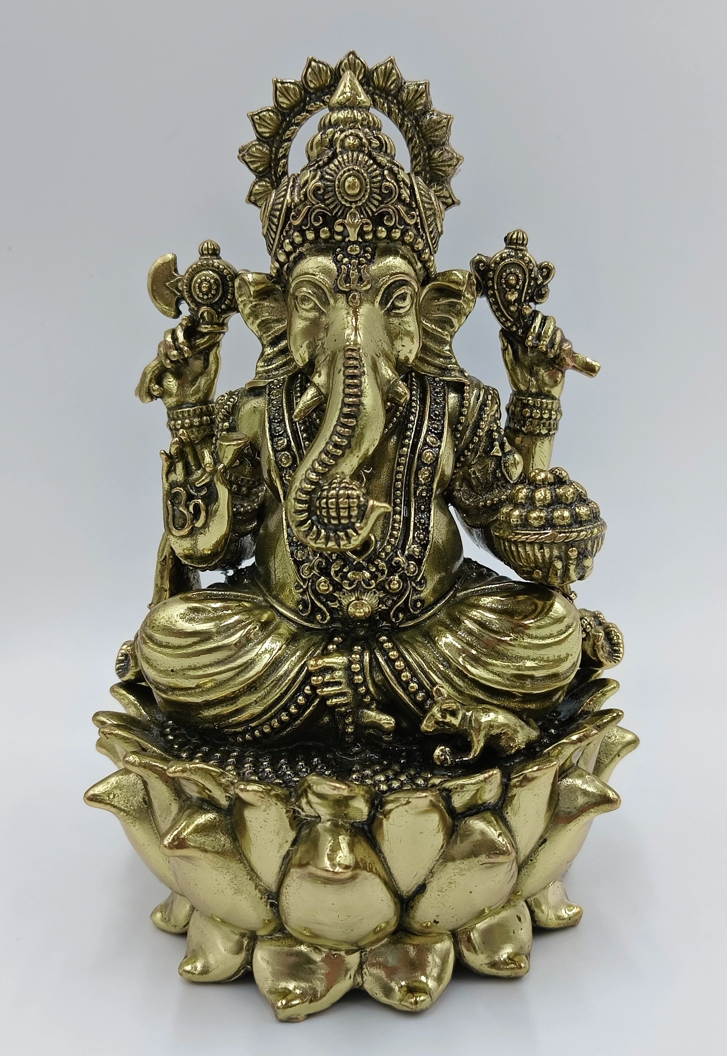 Medium brass statue of Lord Ganesh sitting on a lotus flower base