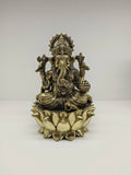 Medium brass statue of Lord Ganesh seated on a lotus flower
