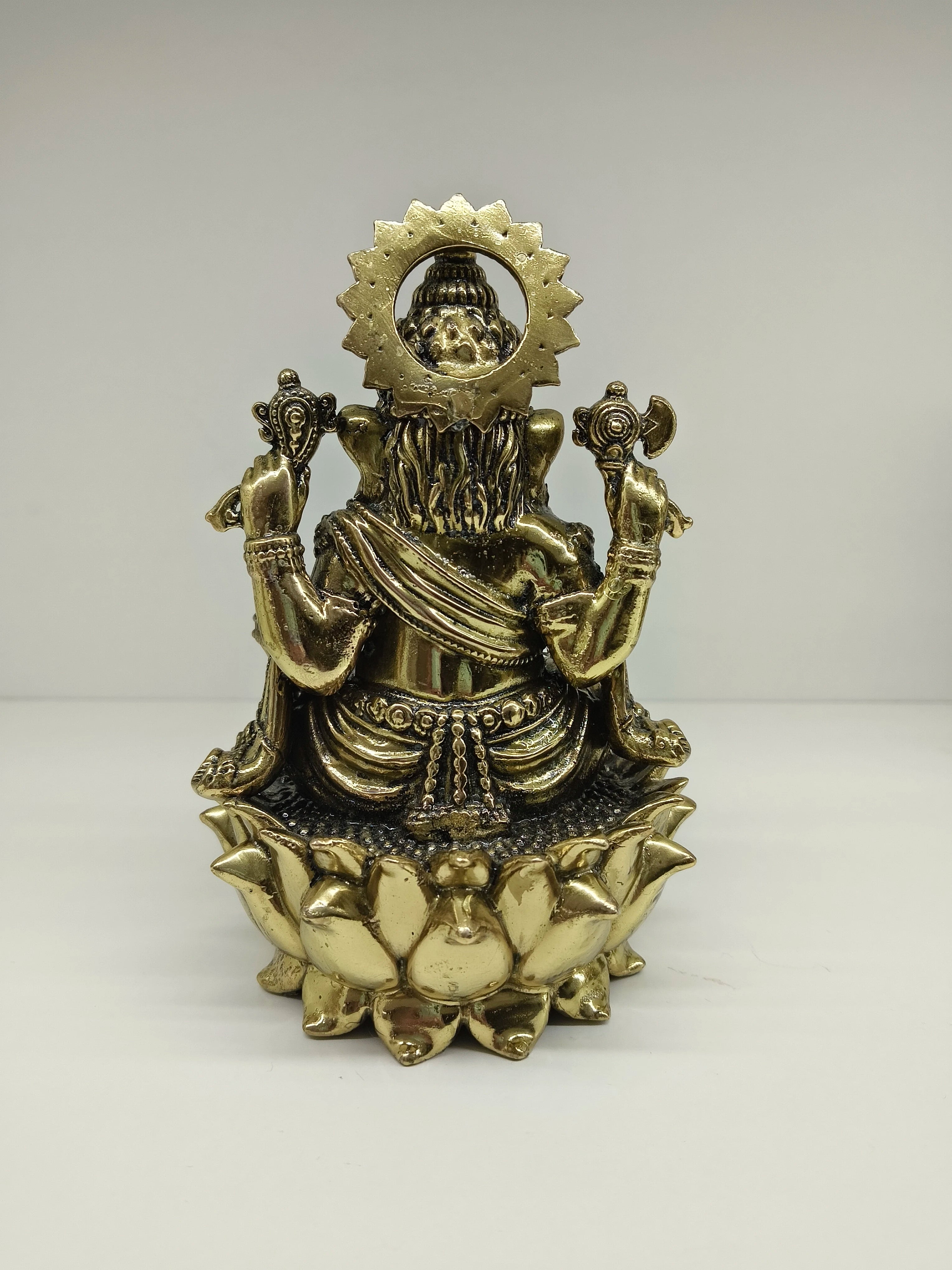 Rear view of medium brass Ganesh statue seated on lotus pedestal