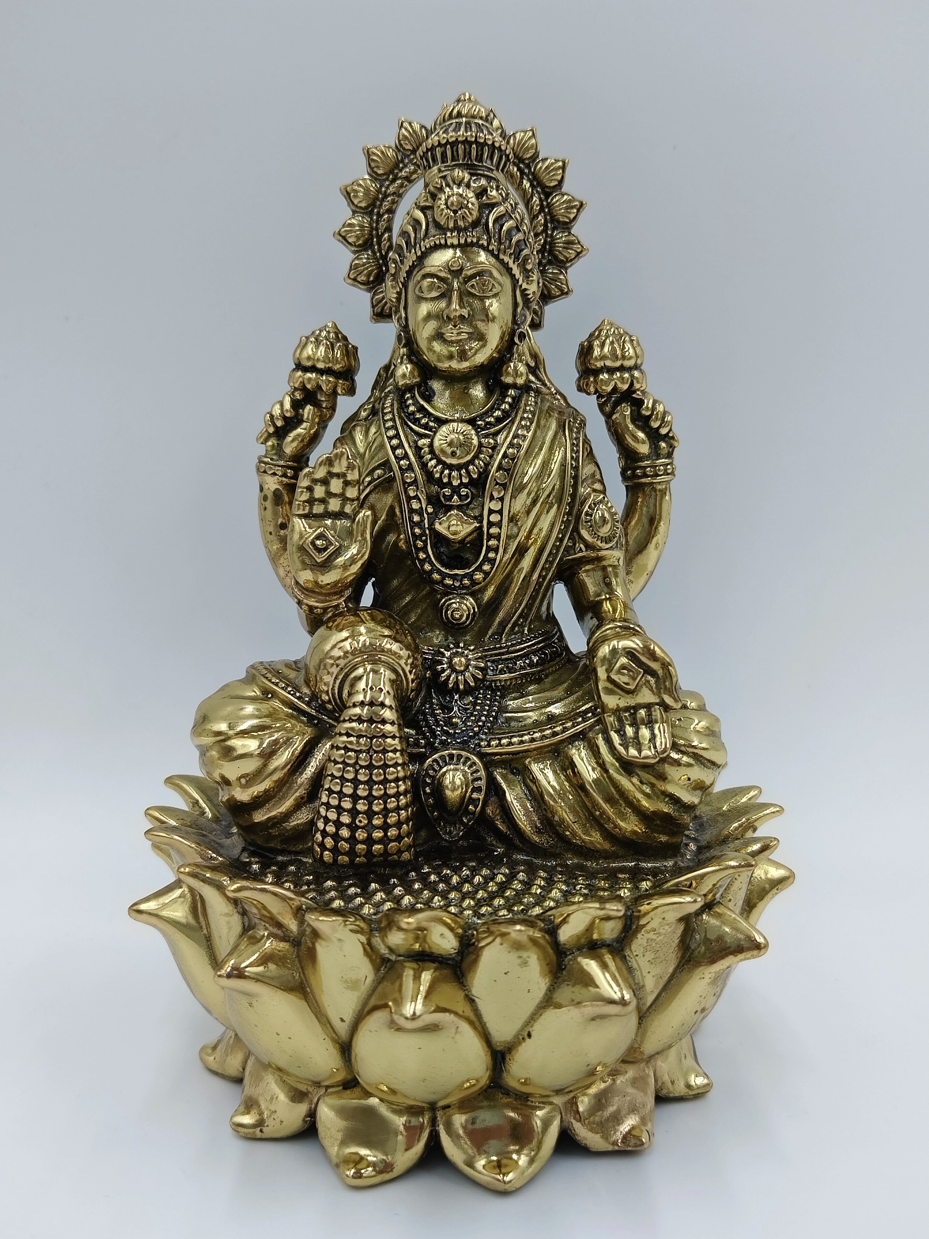 Medium brass statue of Goddess Lakshmi seated on a lotus flower