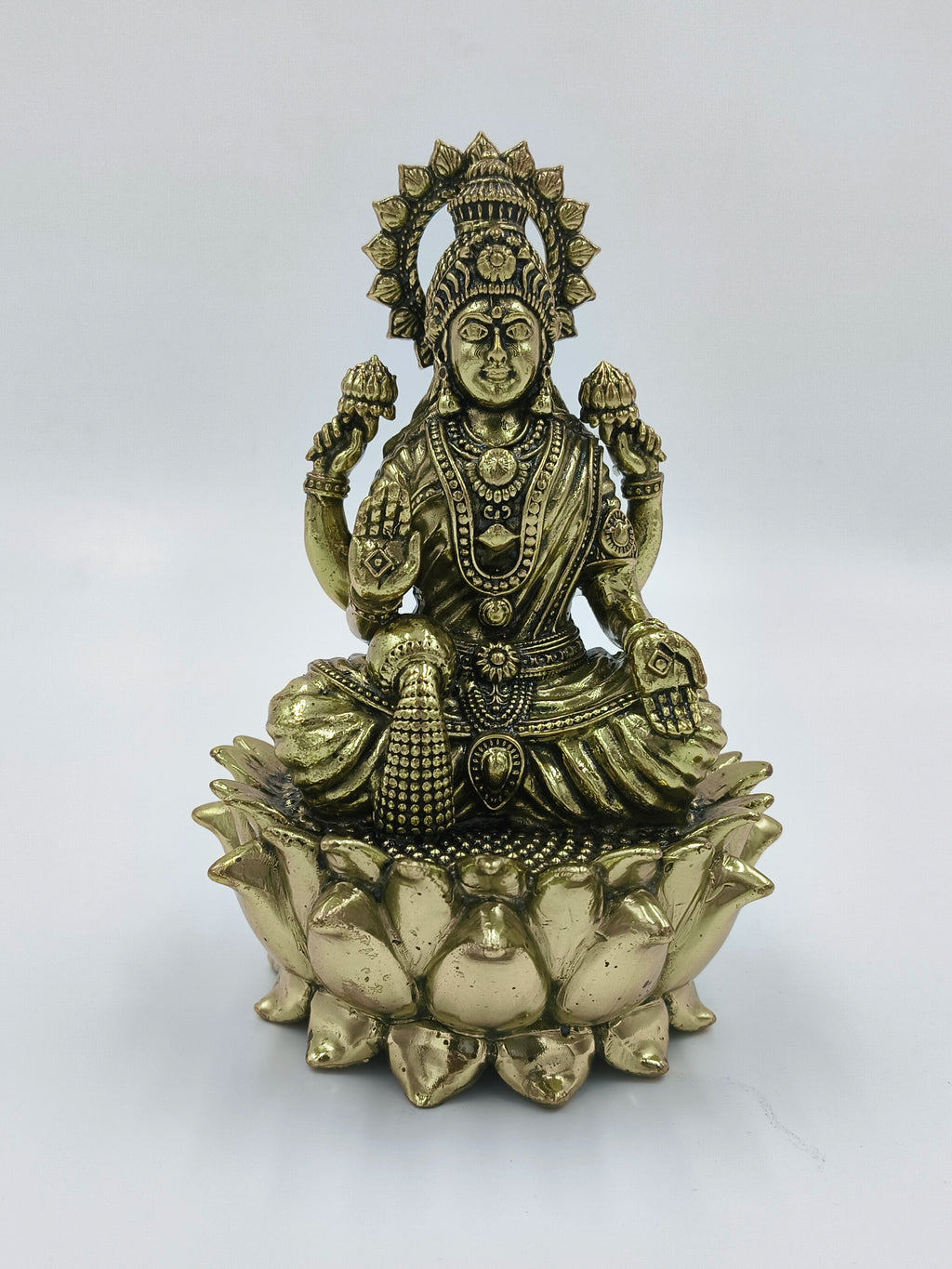 Brass sculpture of Goddess Lakshmi seated on a lotus flower