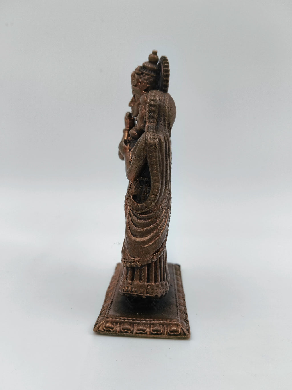 Side view of small copper brass Radha Krishna standing sculpture on rectangular base