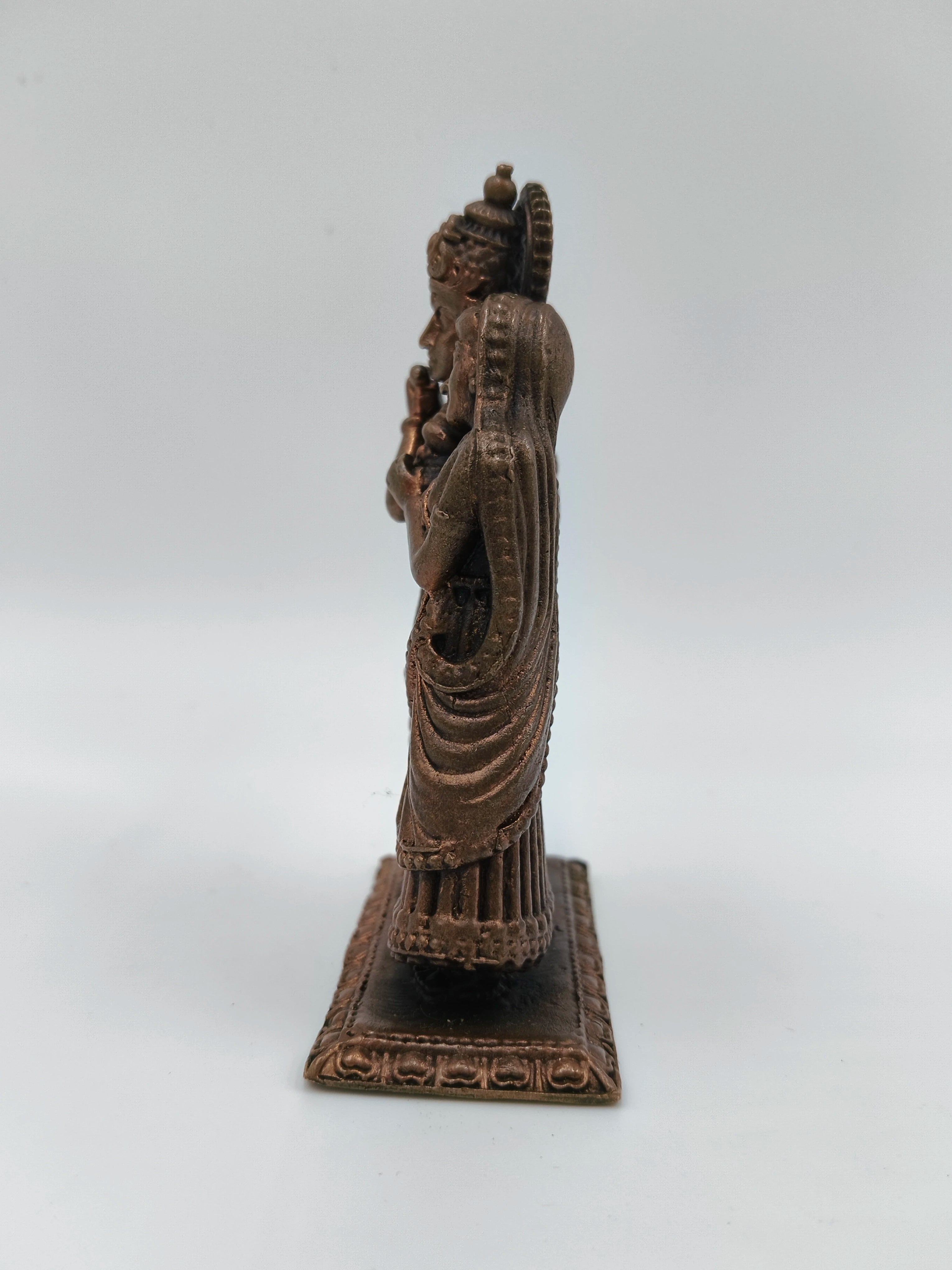 Side view of small copper brass Radha Krishna standing sculpture on rectangular base