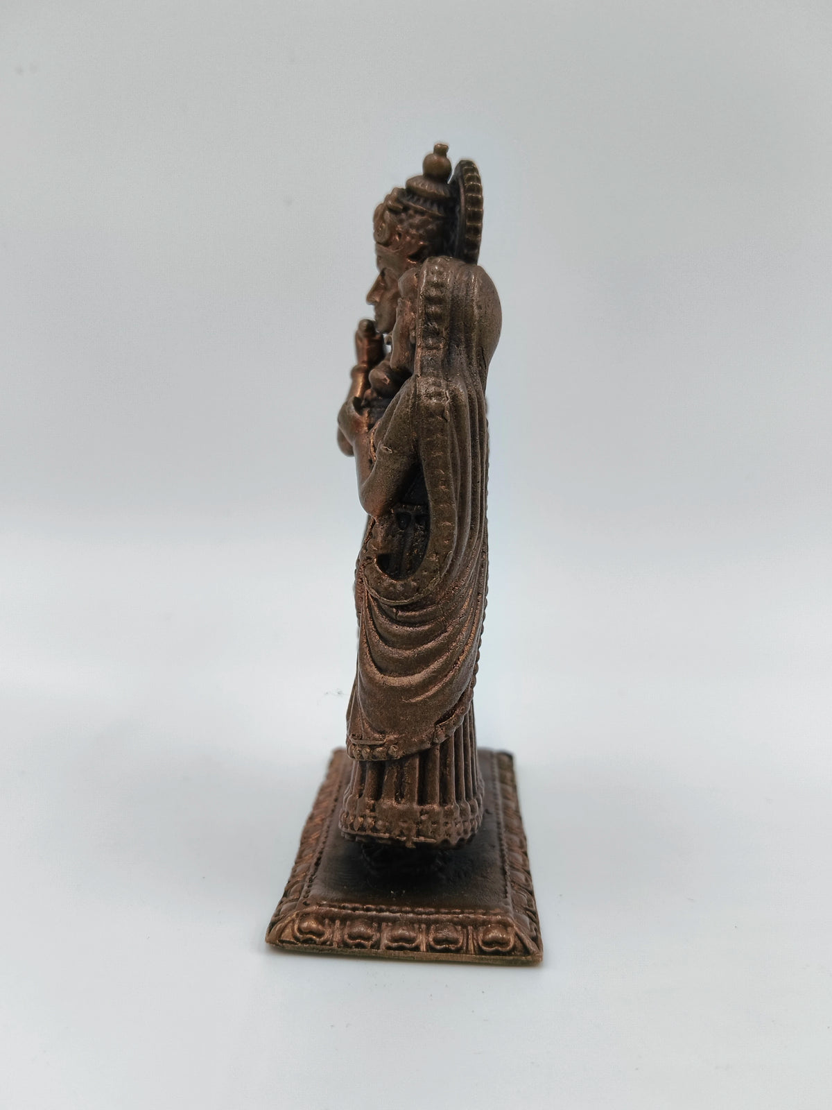 Side view of small copper brass Radha Krishna standing sculpture on rectangular base