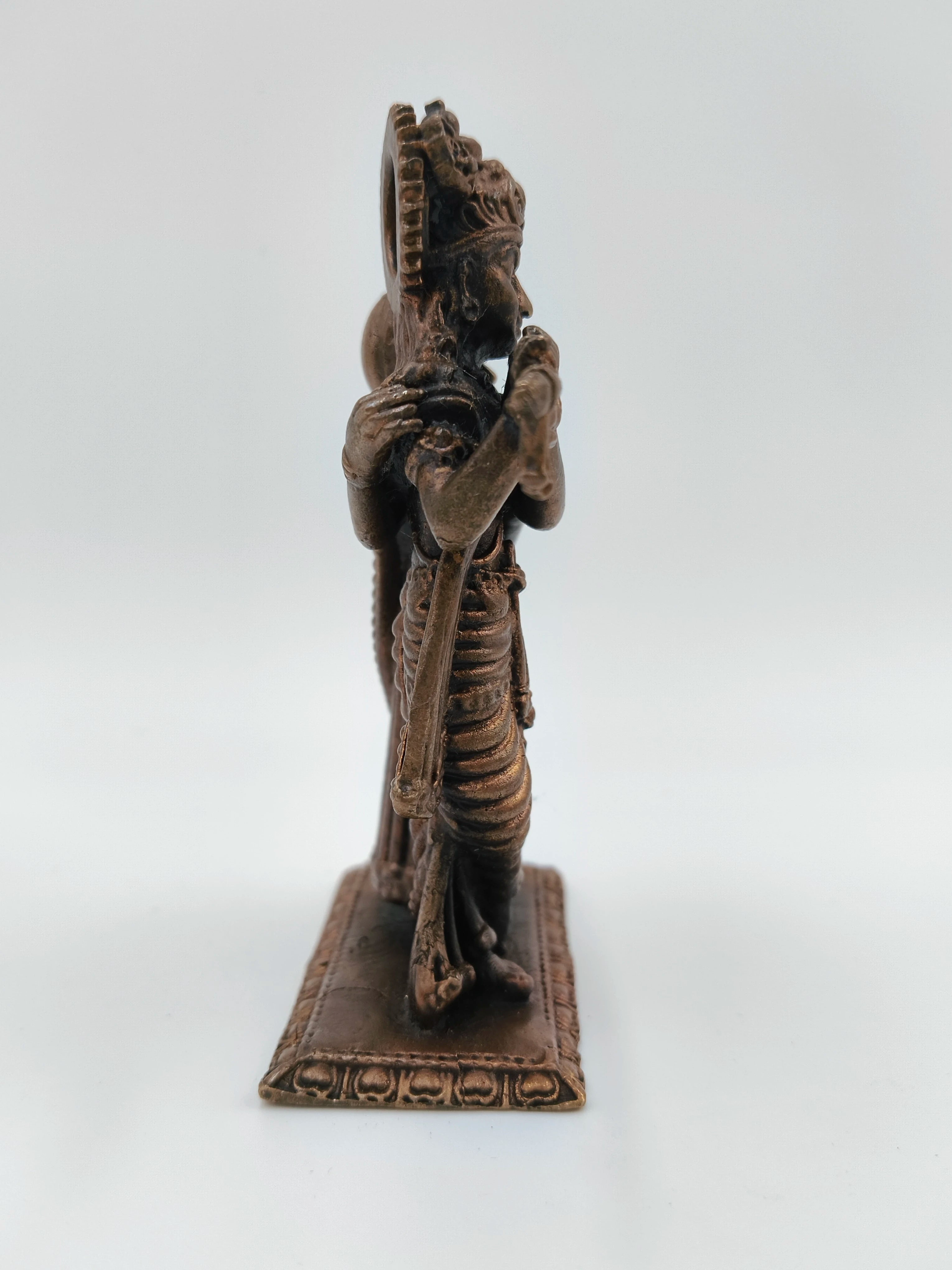Side view of small brass Radha Krishna standing sculpture on rectangular base