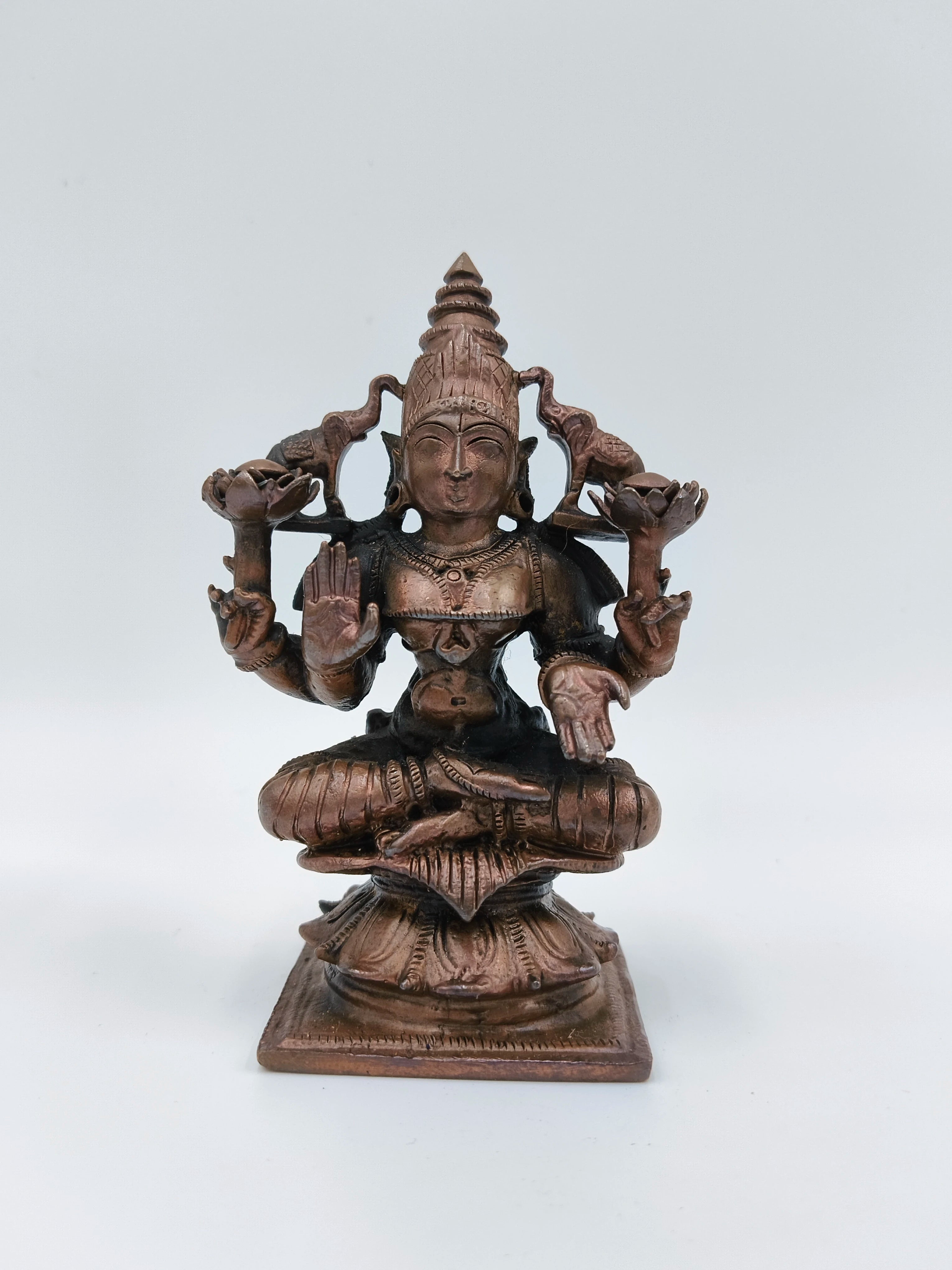 Small brass copper sculpture of seated Goddess Lakshmi on lotus pedestal