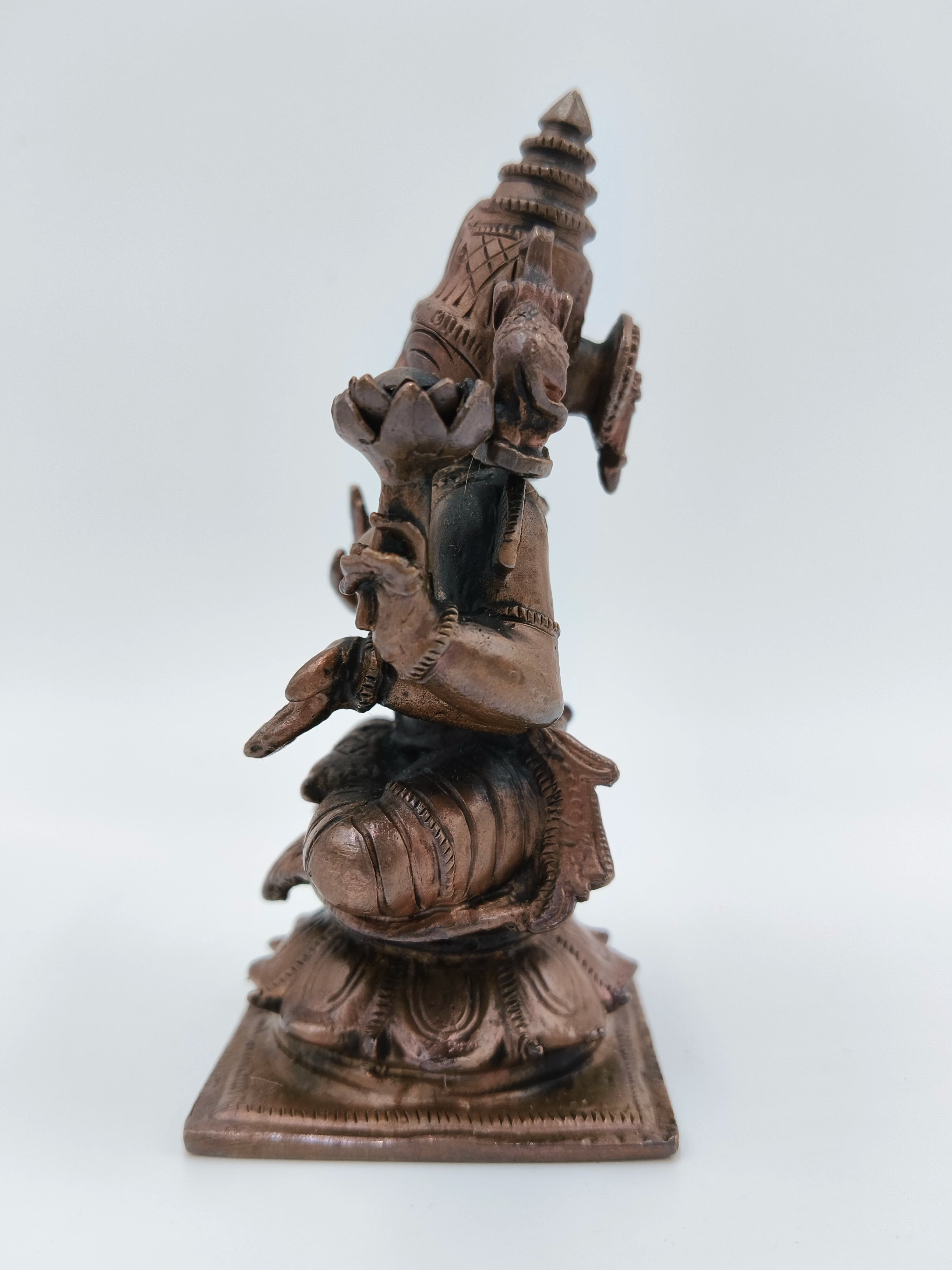 Small brass sculpture of Goddess Lakshmi sitting in serene posture