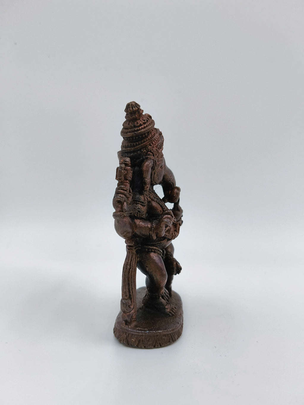 Small brass statue of Lord Ganesh in dancing pose side view