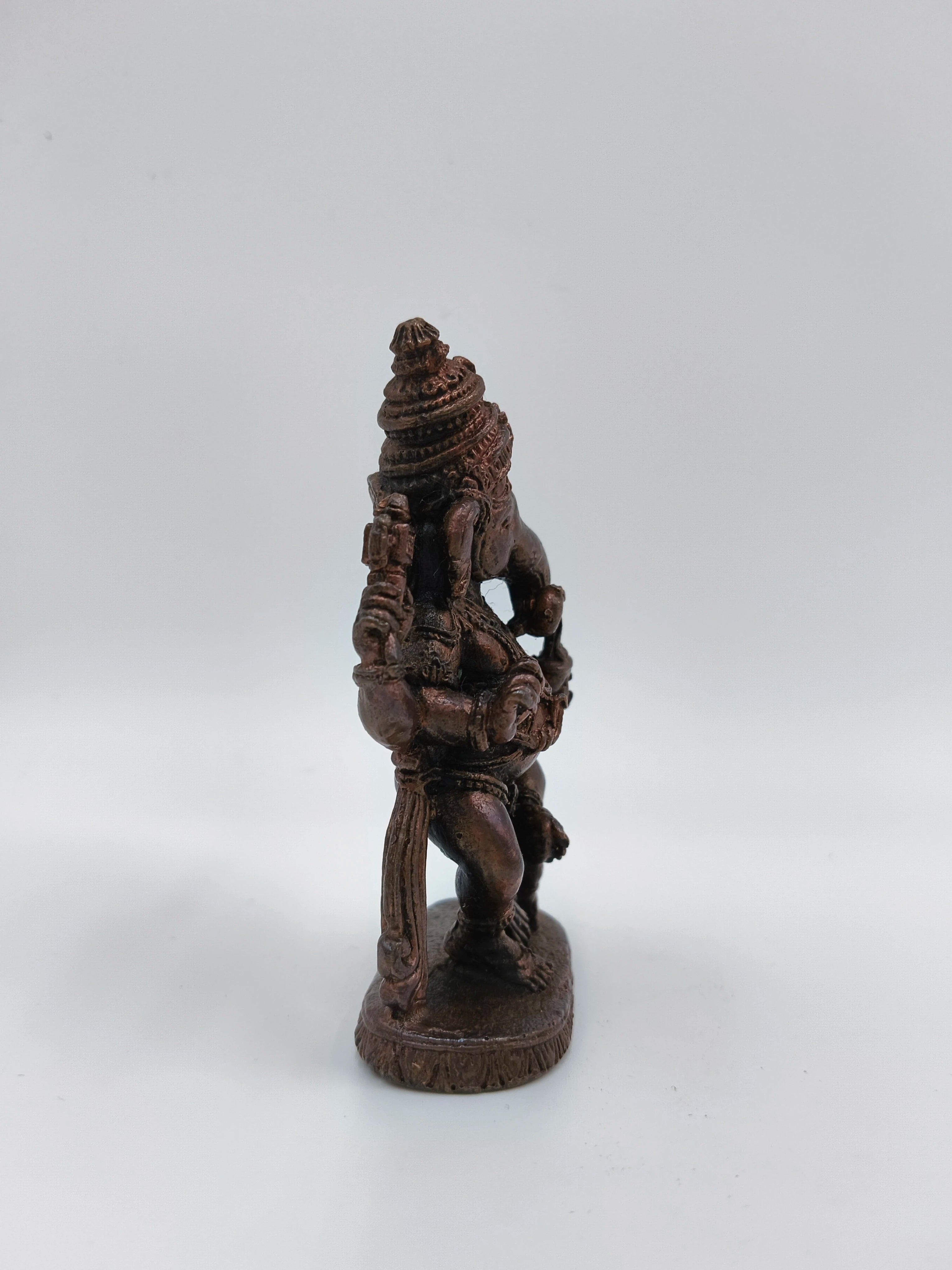 Small brass statue of Lord Ganesh in dancing pose side view