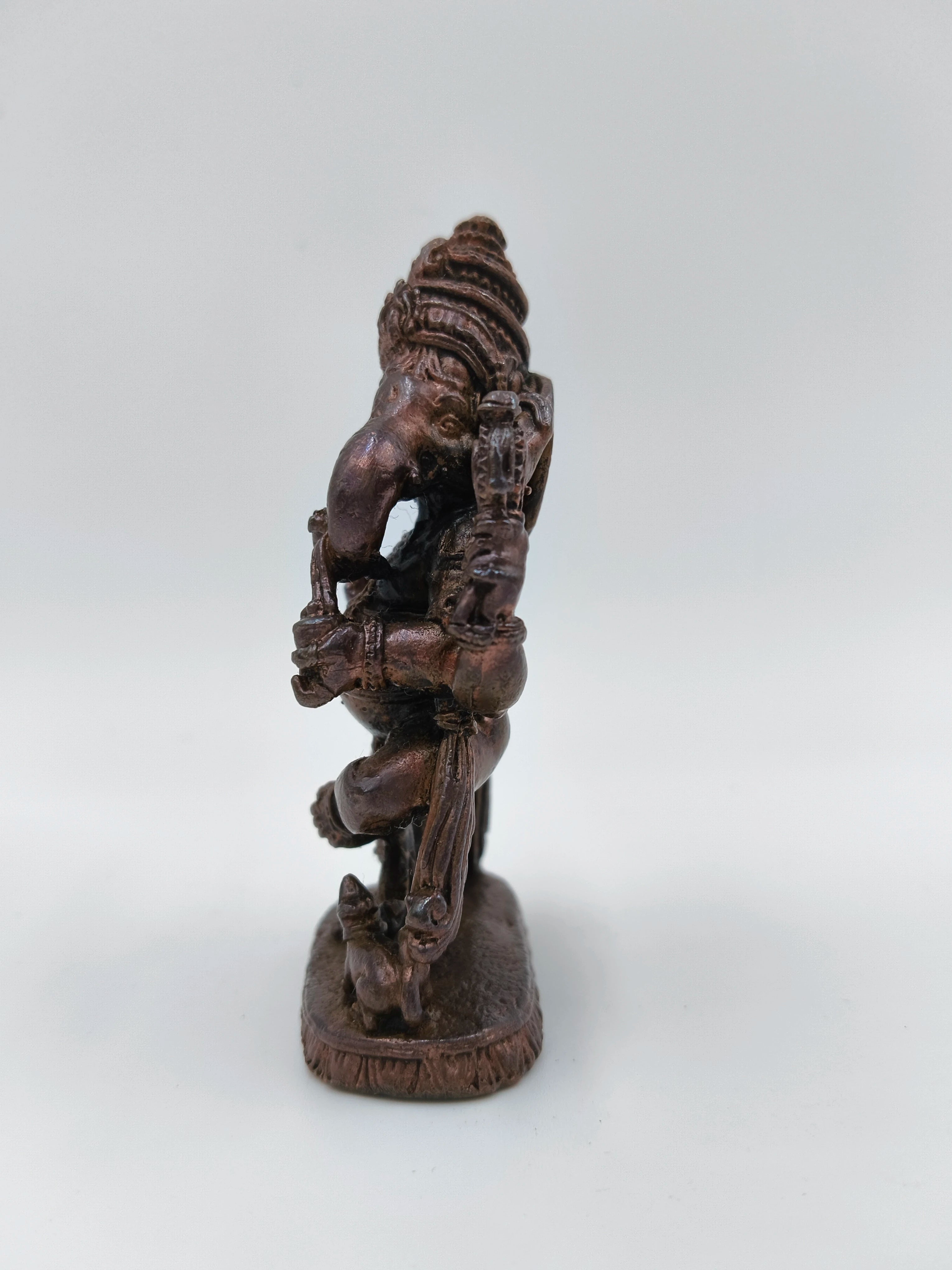 Small brass statue of Lord Ganesh in dancing pose side view