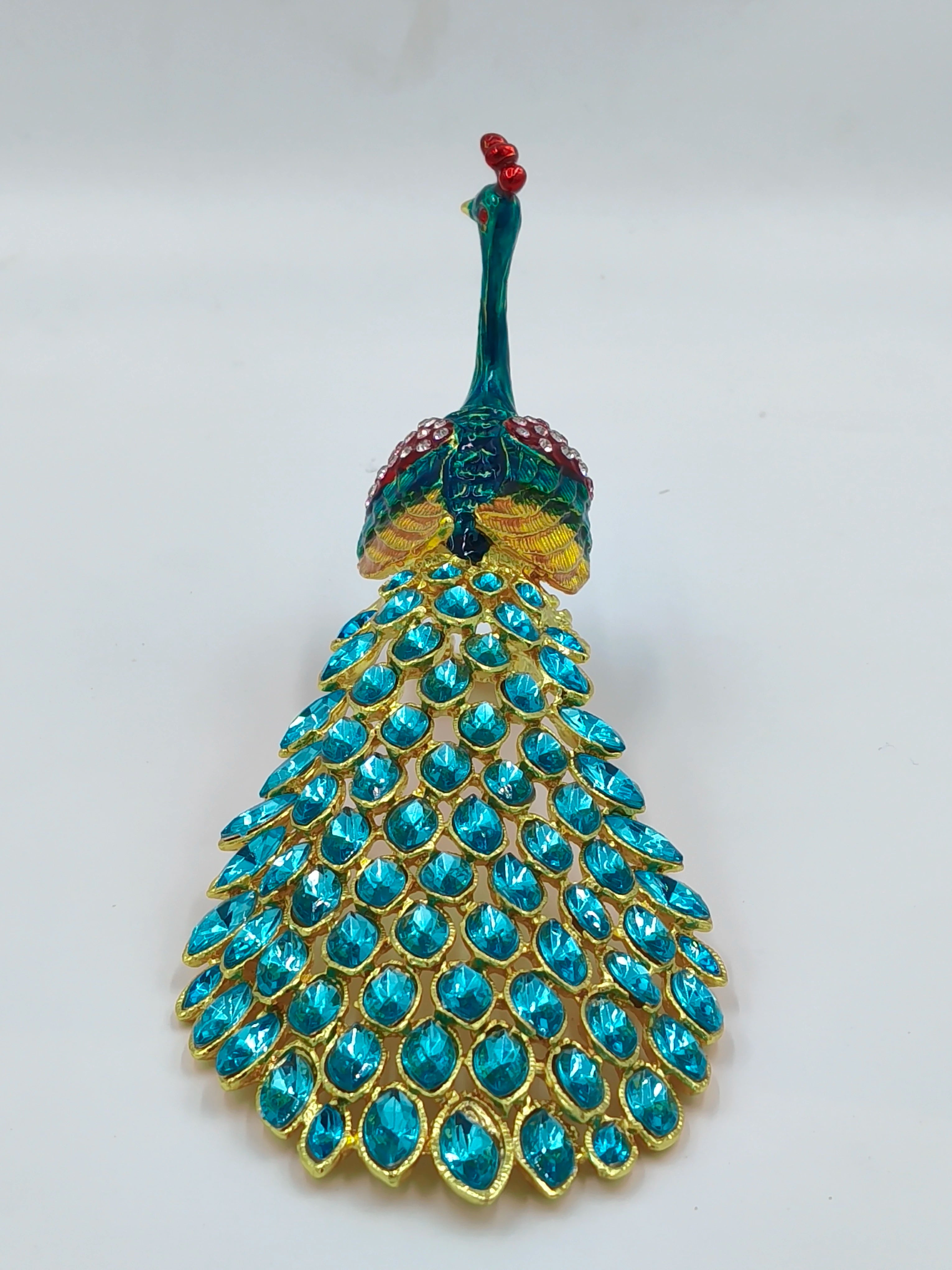 Small brass peacock figurine with copper enamel and blue gemstone tail