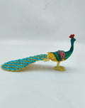 Small brass peacock figurine with copper enamel detailing side view