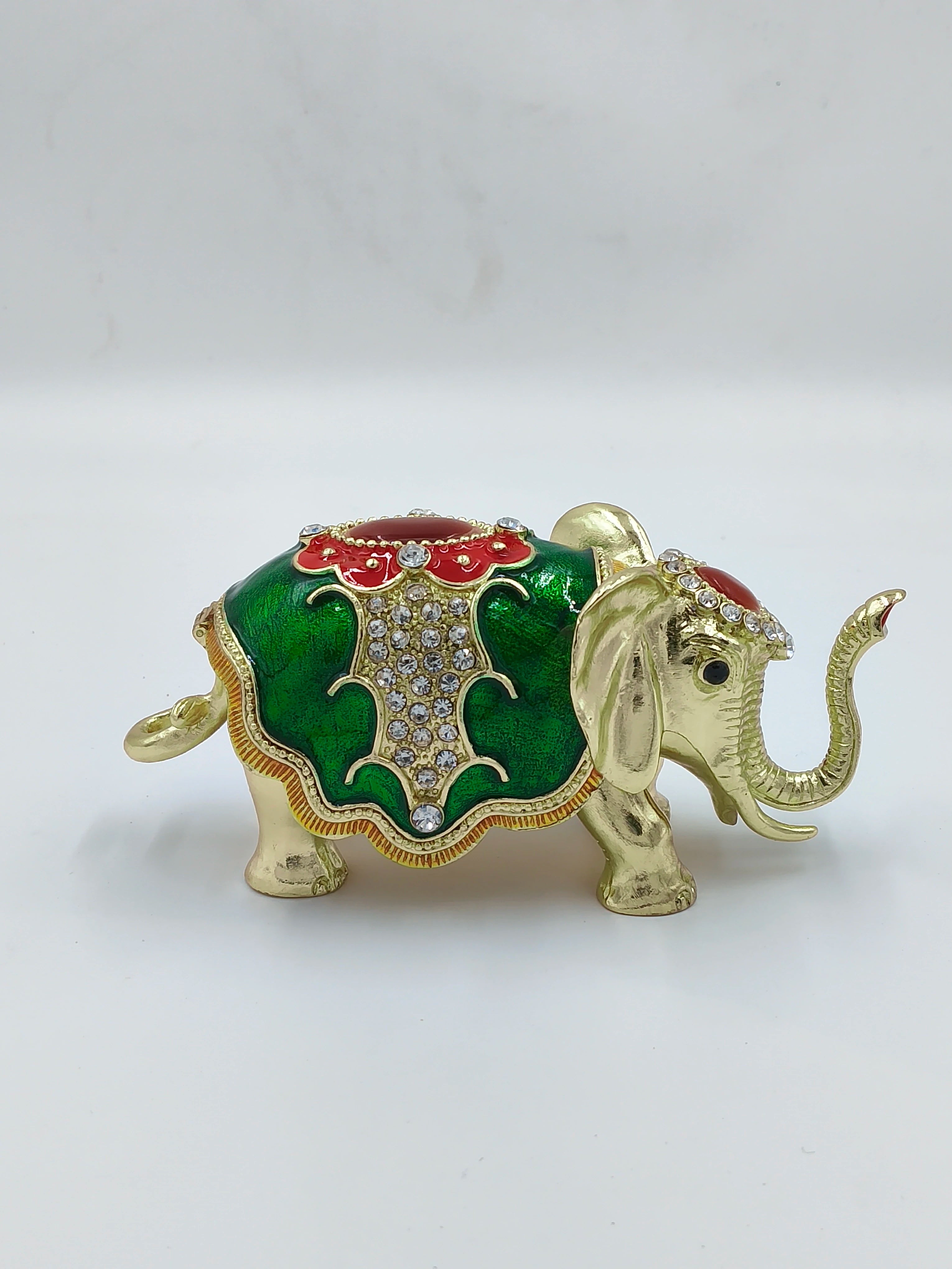 Small brass elephant figurine with green and red copper enamel and rhinestone accents