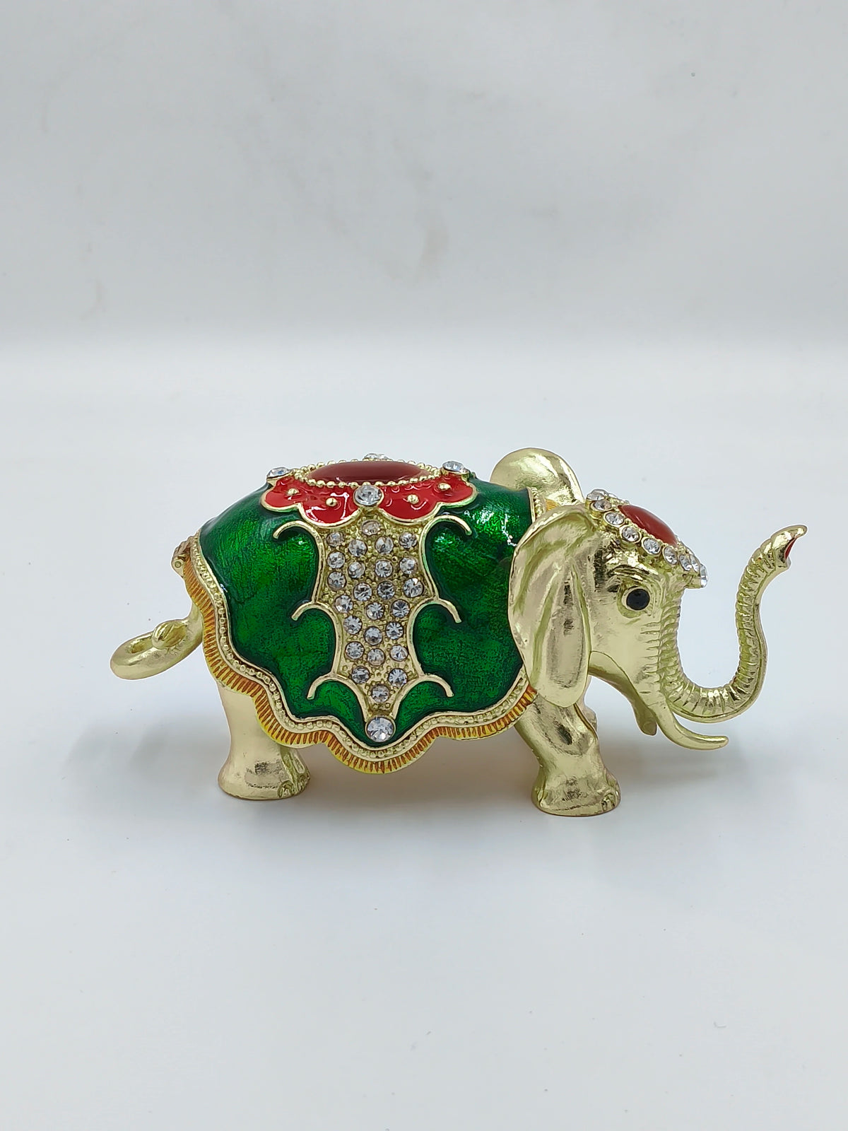 Small brass elephant figurine with green and red copper enamel and rhinestone accents