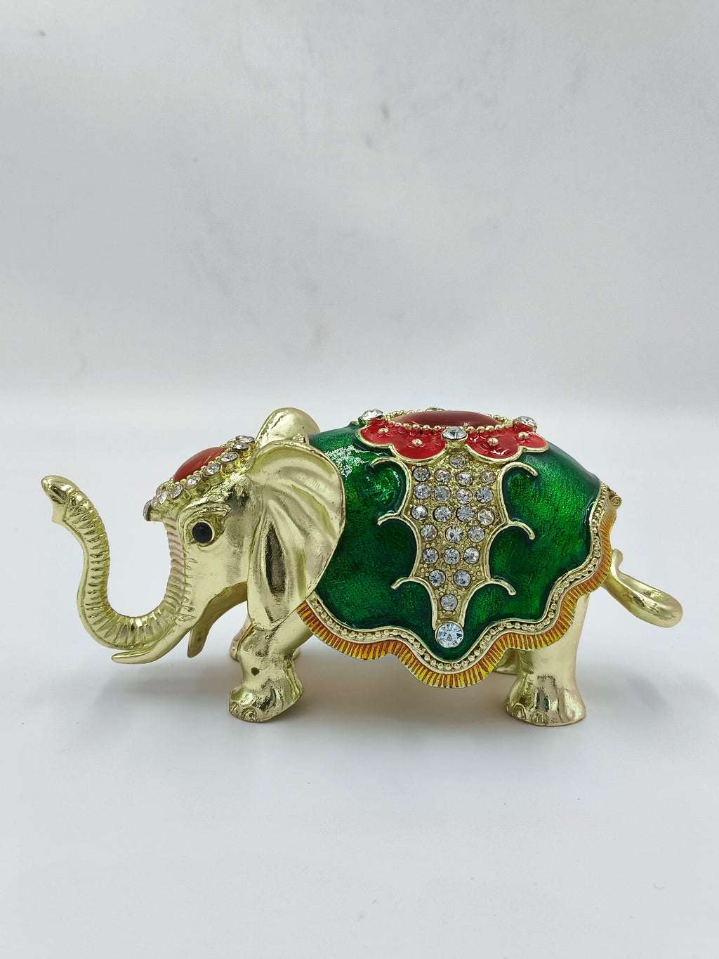Small brass elephant figurine with green enamel and rhinestone decorations