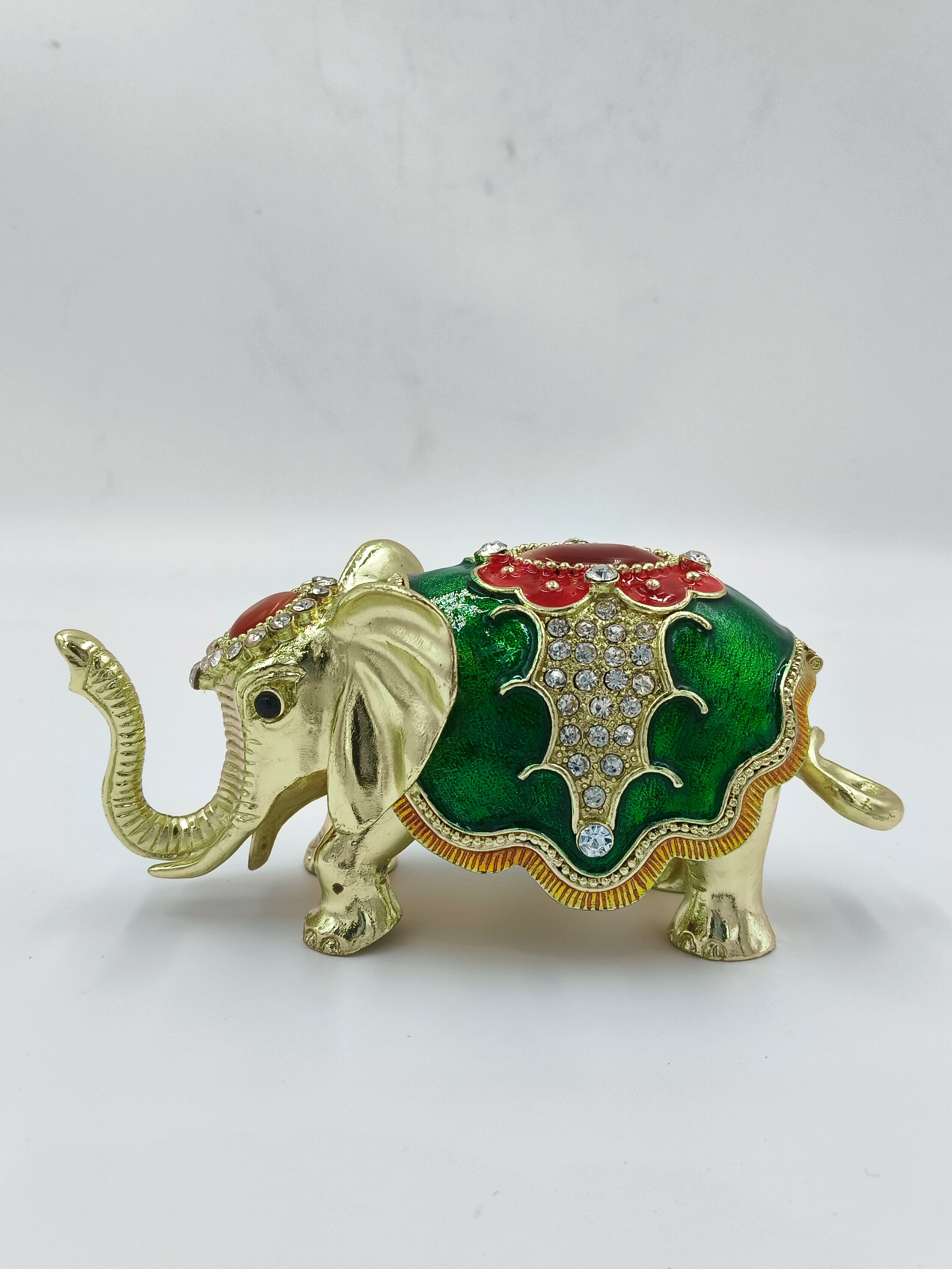 Small brass elephant figurine with green enamel and rhinestone decorations