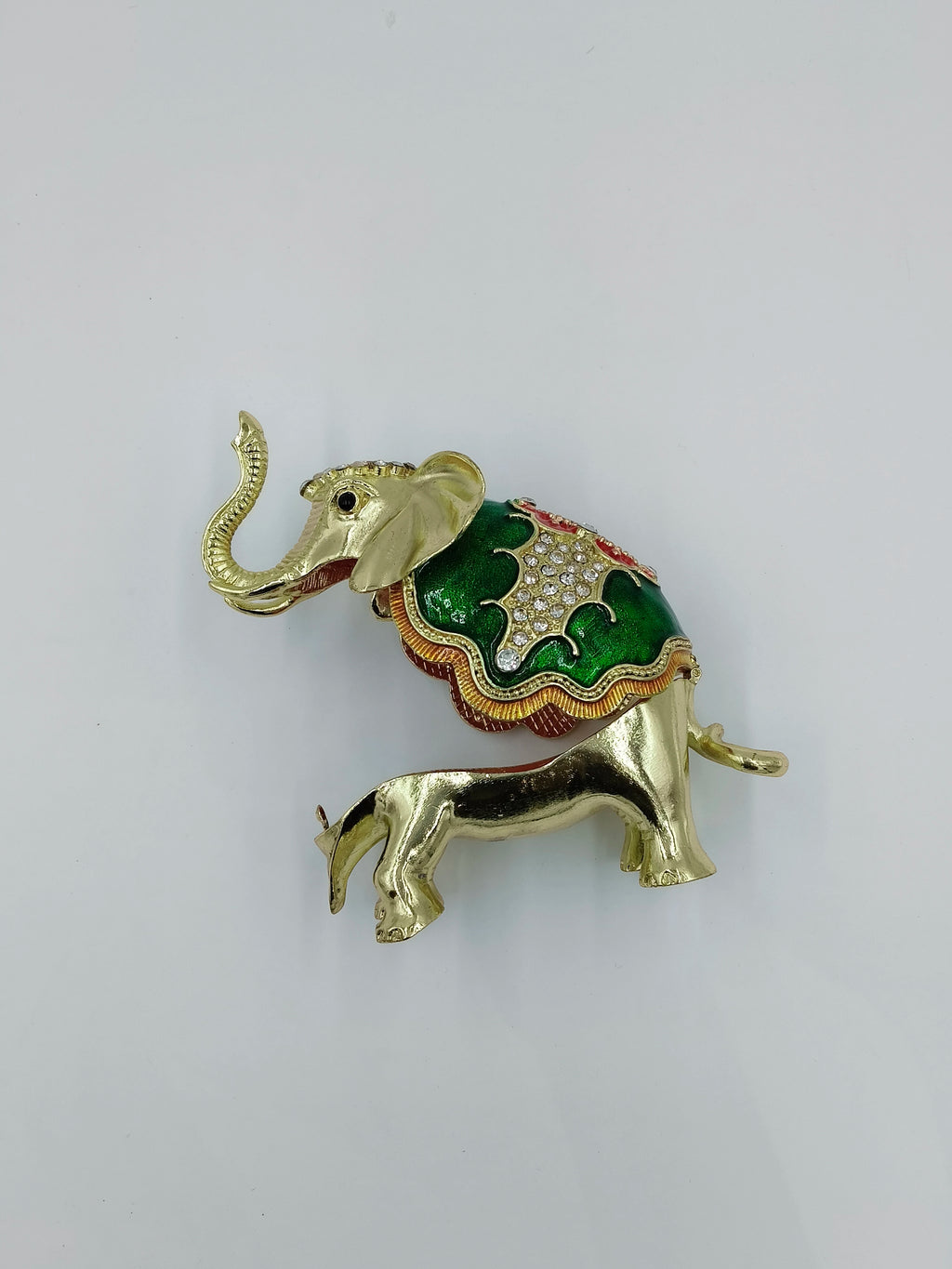Small brass elephant figurine with green and copper enamel decoration