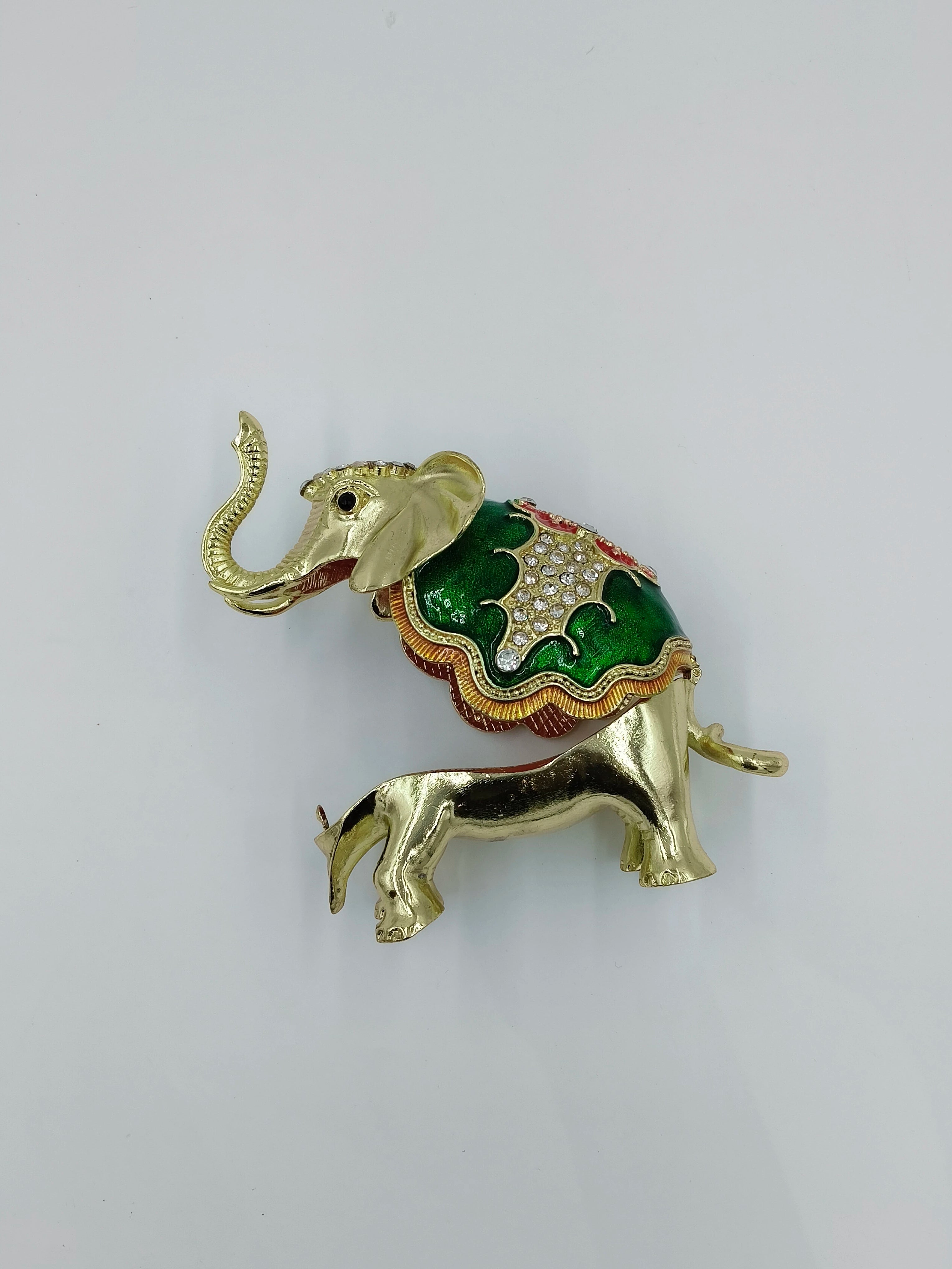 Small brass elephant figurine with green and copper enamel decoration