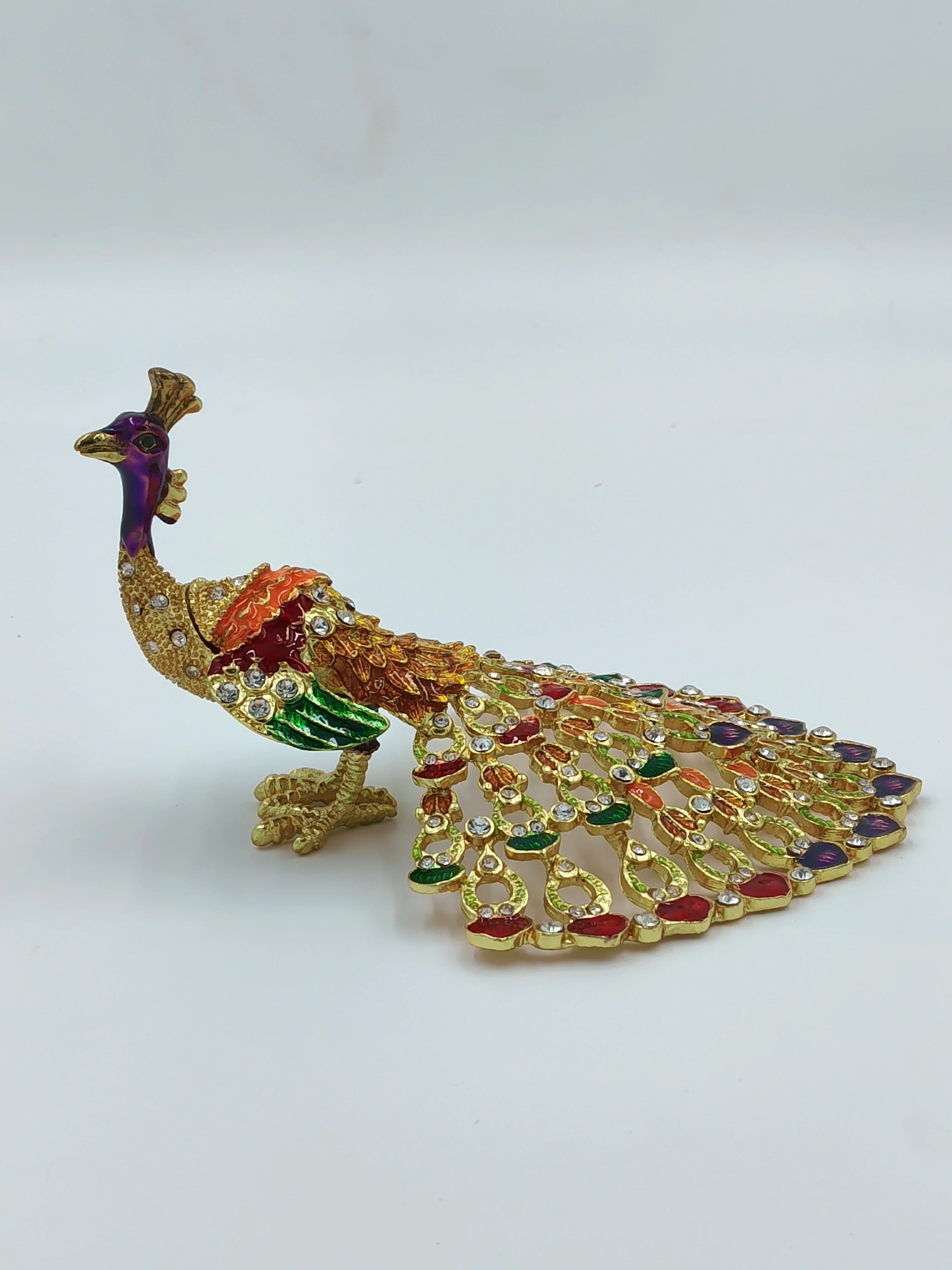 Small brass peacock figurine with copper enamel and rhinestone details side view