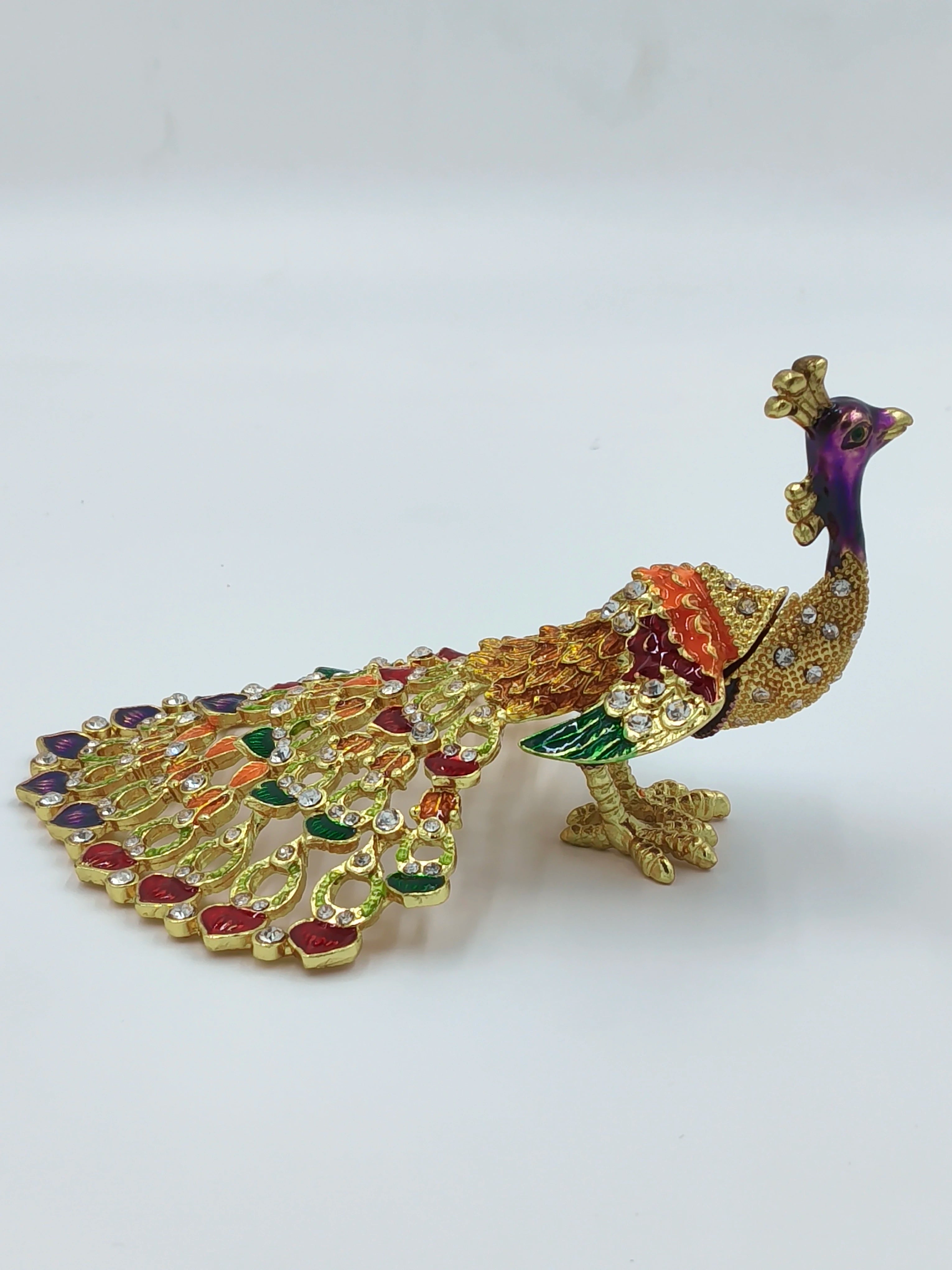 Small brass peacock figurine with copper enamel and rhinestone accents side view