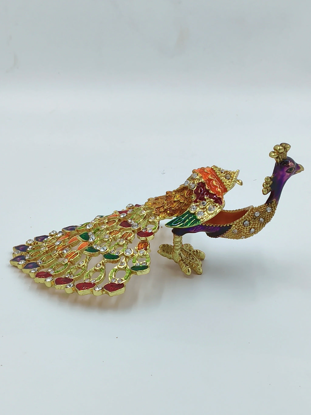 Small brass peacock figurine with copper enamel and rhinestone embellishments