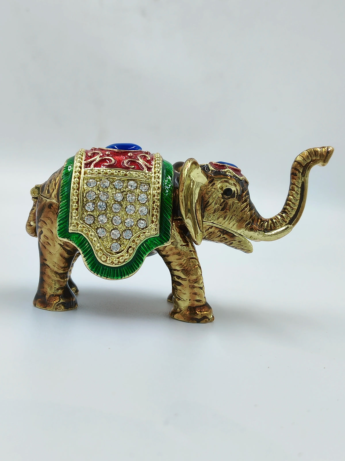 Mini brass elephant figurine with copper enamel and decorative stones side view