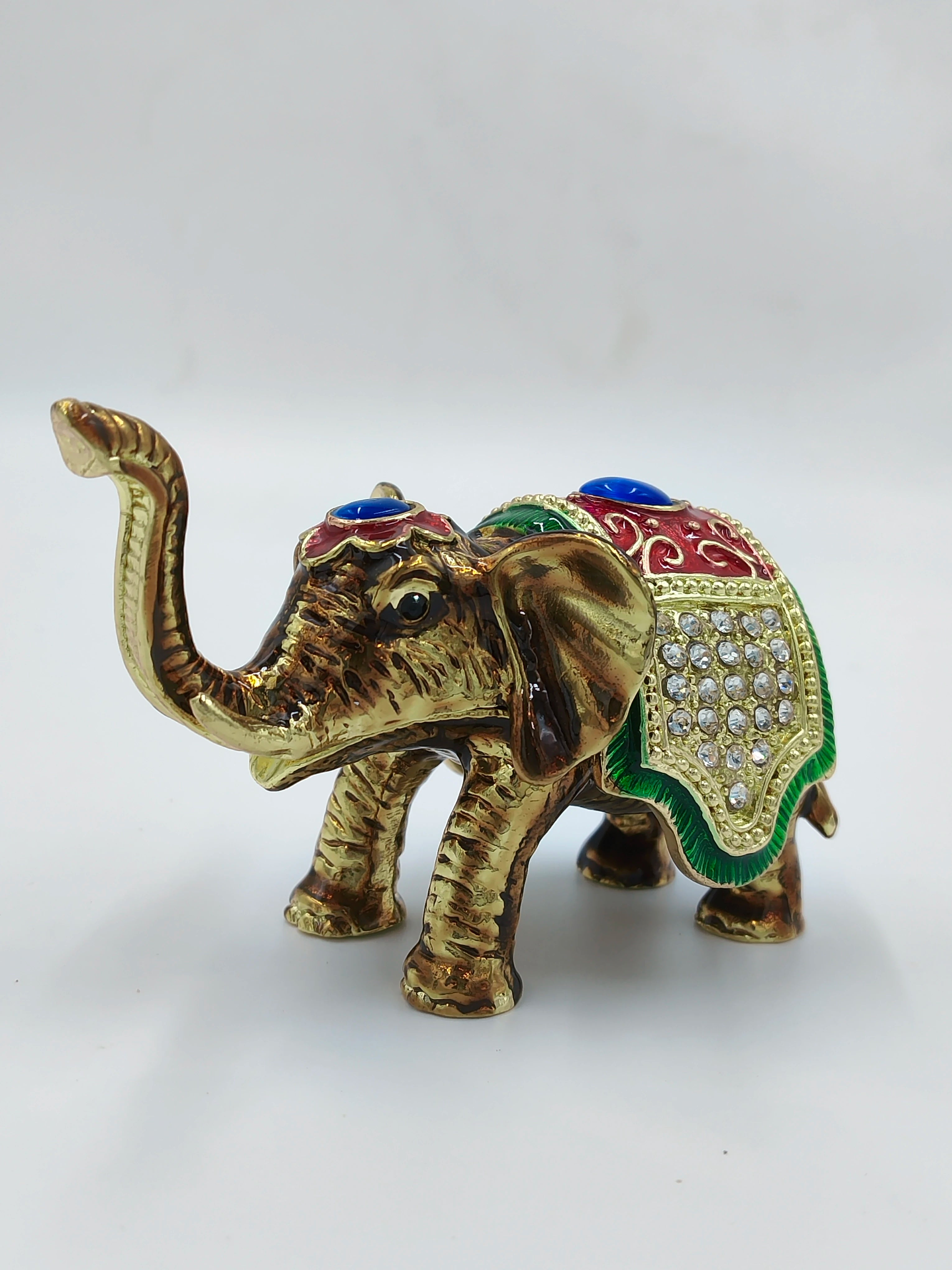 Mini brass elephant figurine with copper enamel and decorative stones, side view