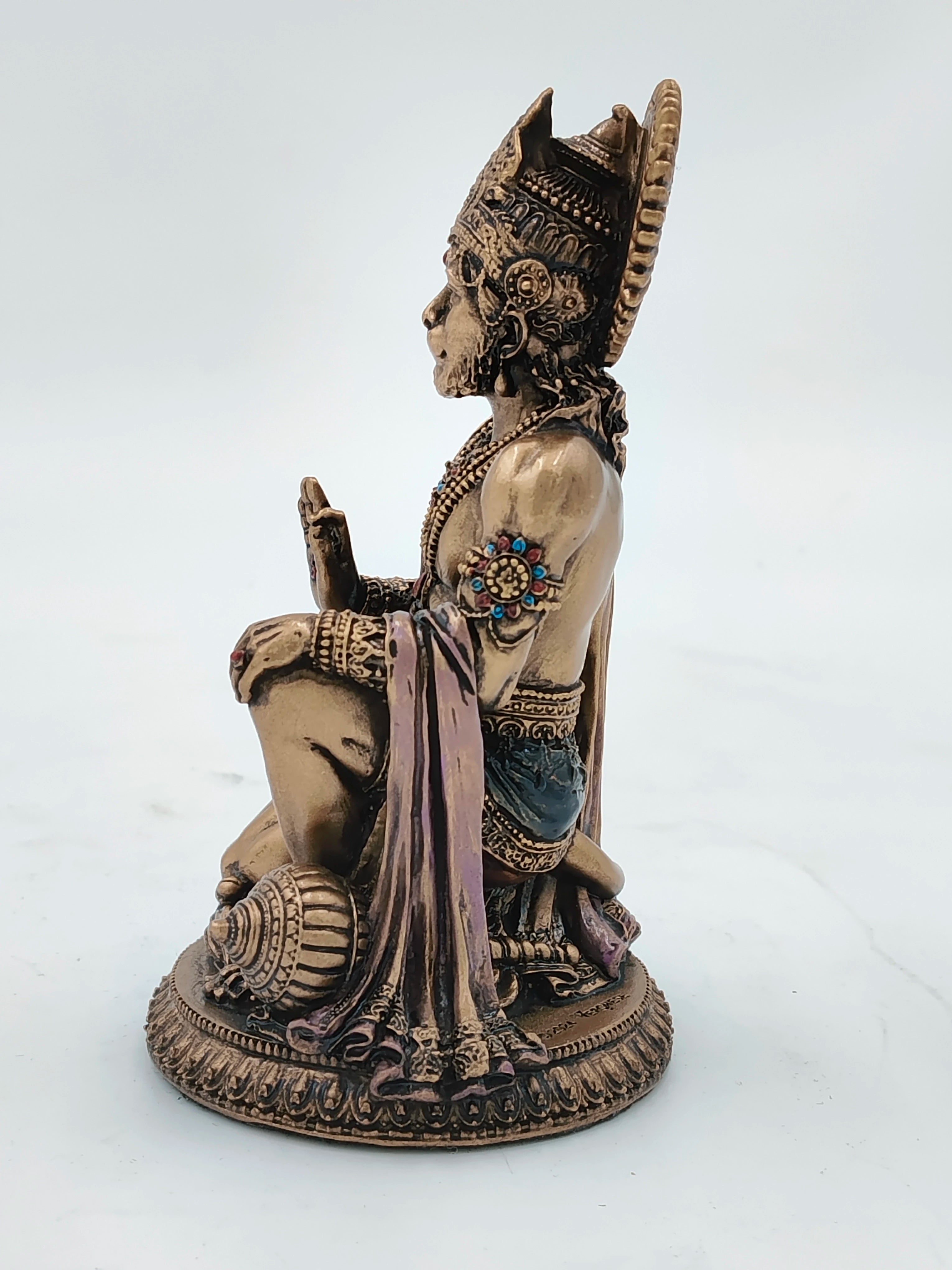 Side view of small polyresin Hanuman statue with intricate details and colored accents