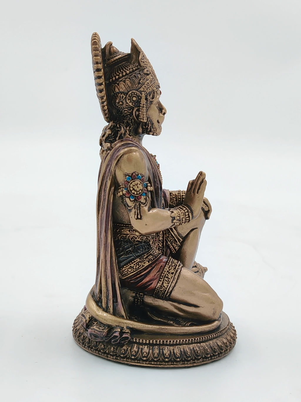 Side view of small polyresin Hanuman statue with detailed ornamentation
