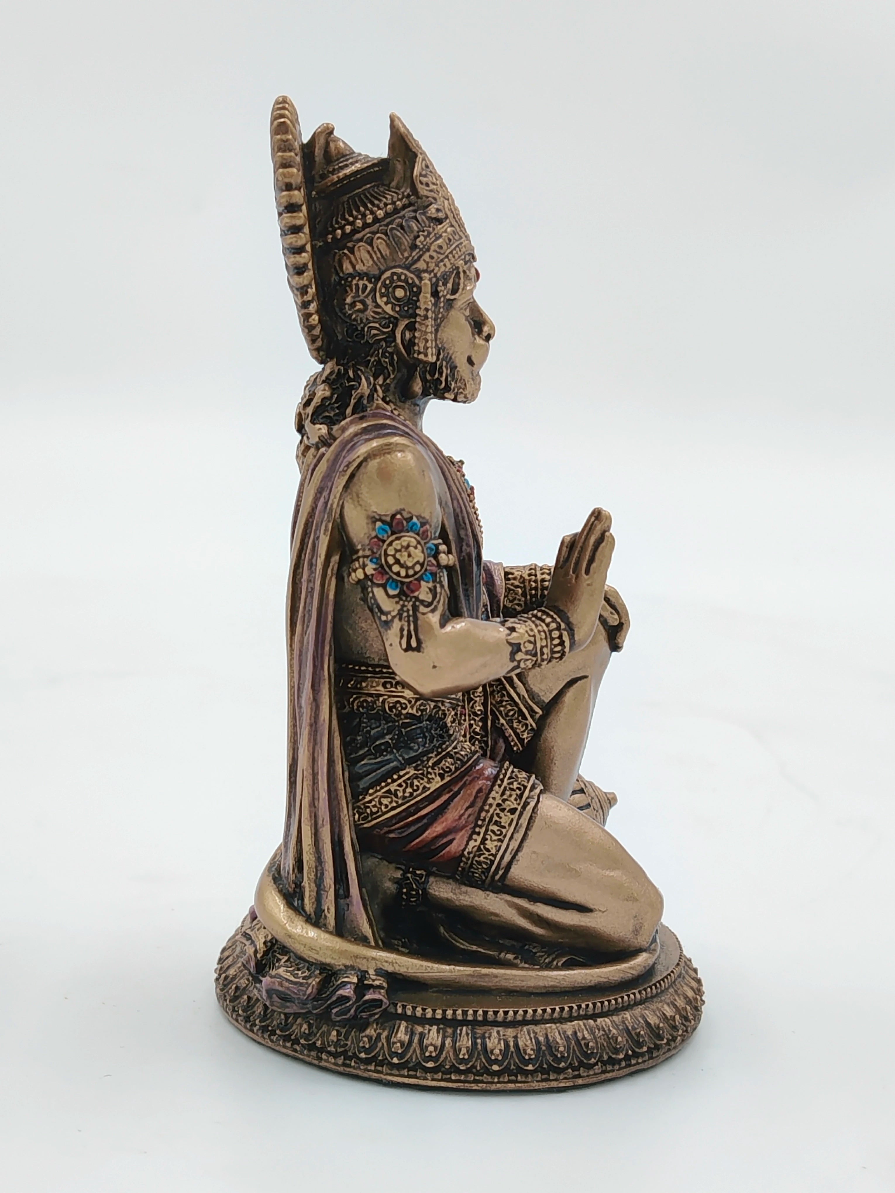 Side view of small polyresin Hanuman statue with detailed ornamentation