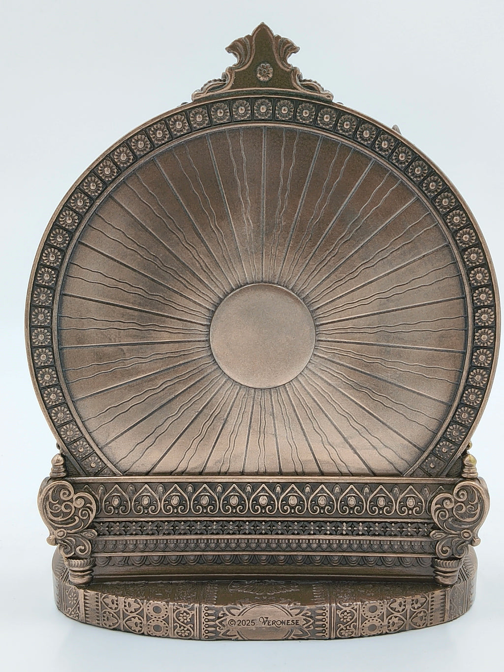ornate bronze-colored circular decorative backplate with intricate floral and geometric patterns