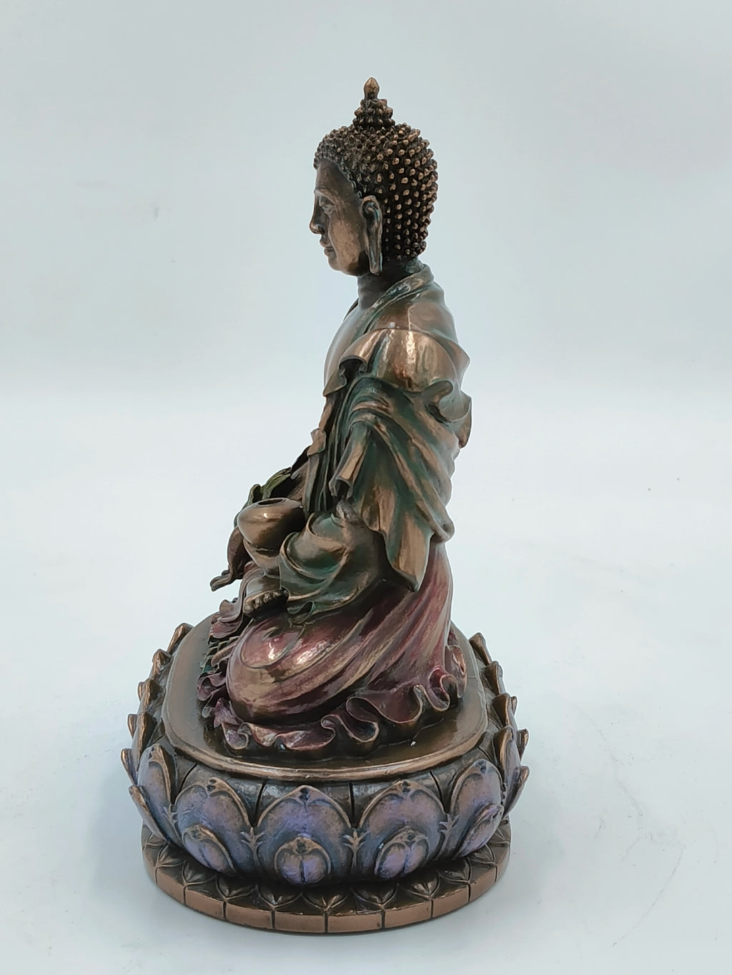 Side view of medium polyresin Buddha statue seated on lotus base
