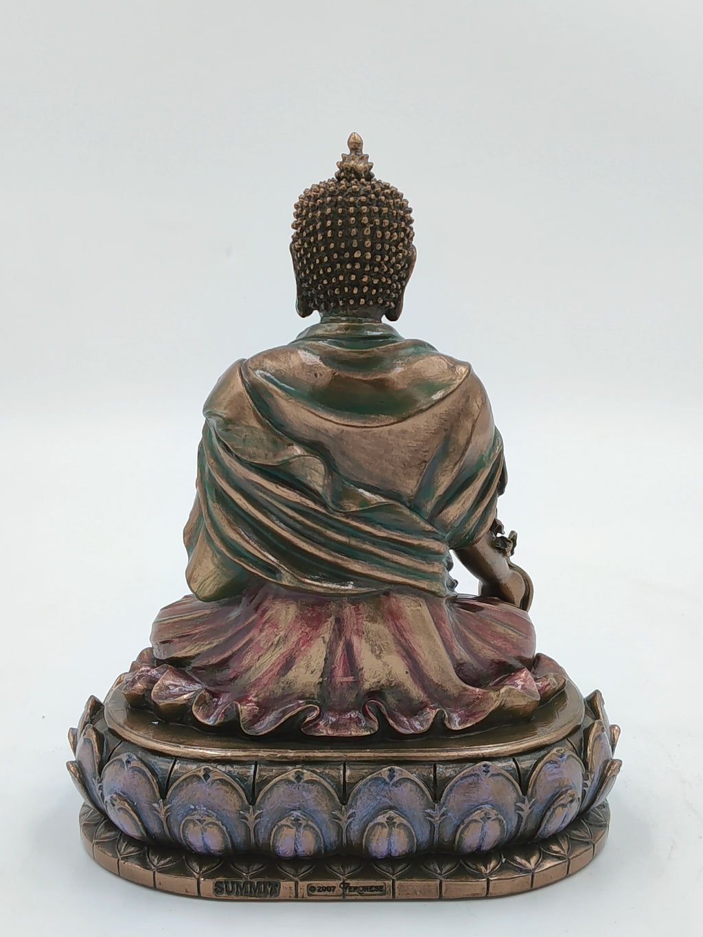 Back view of medium polyresin Buddha statue seated on a lotus base