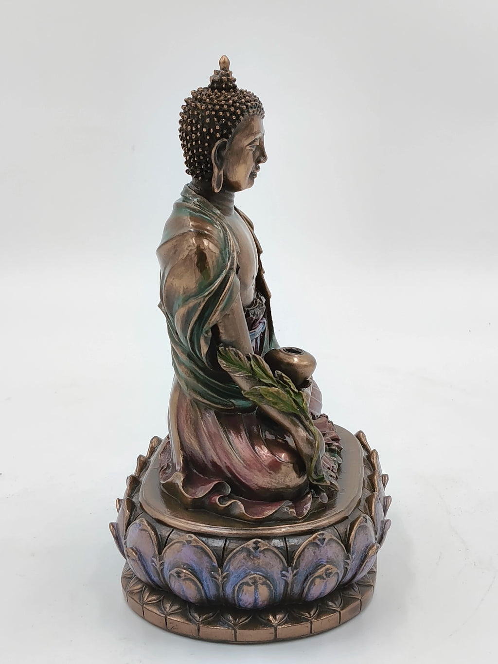 Side view of medium polyresin Buddha statue seated on lotus base