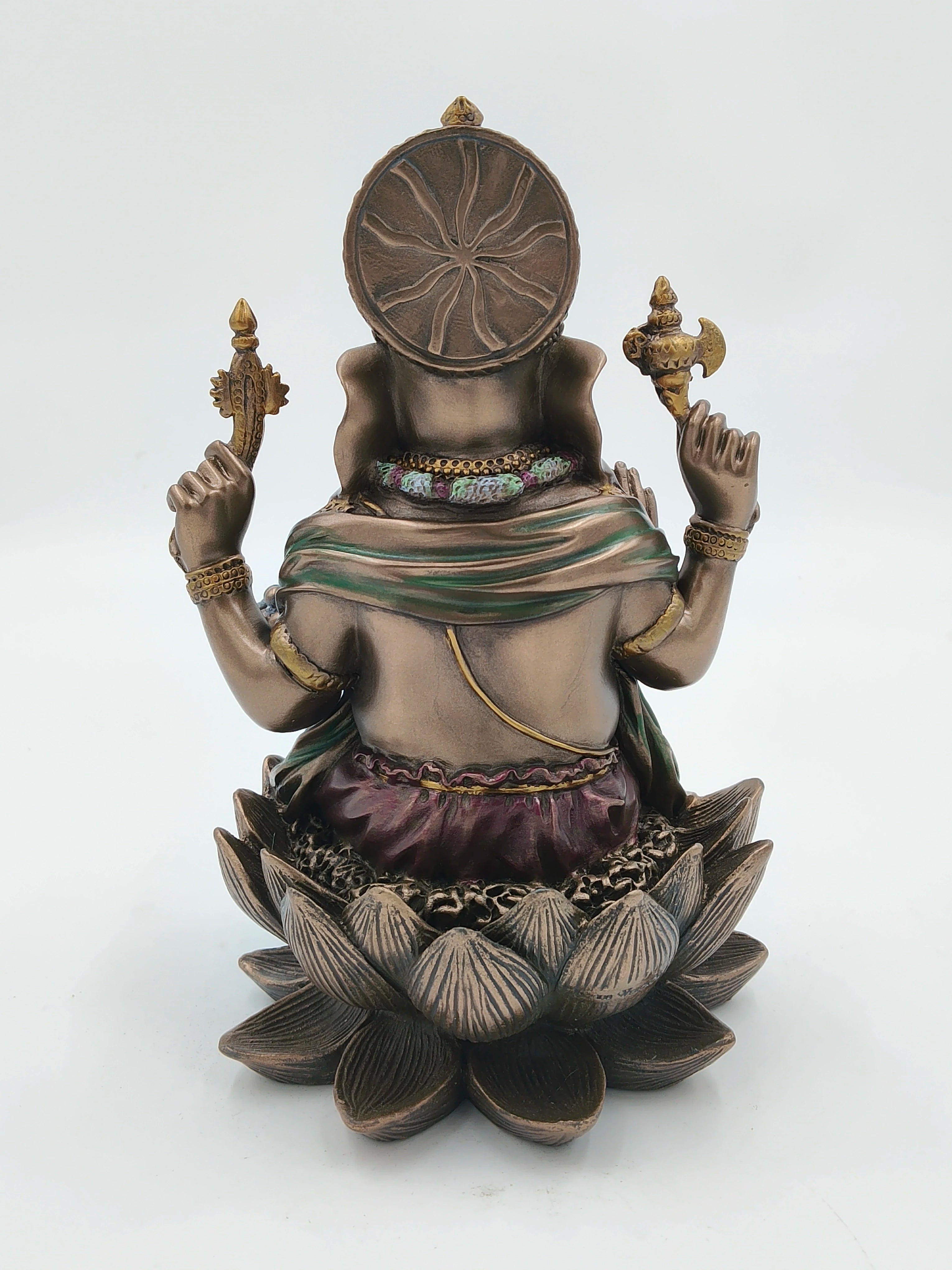Back view of polyresin Ganesh statue seated on a lotus with detailed carvings