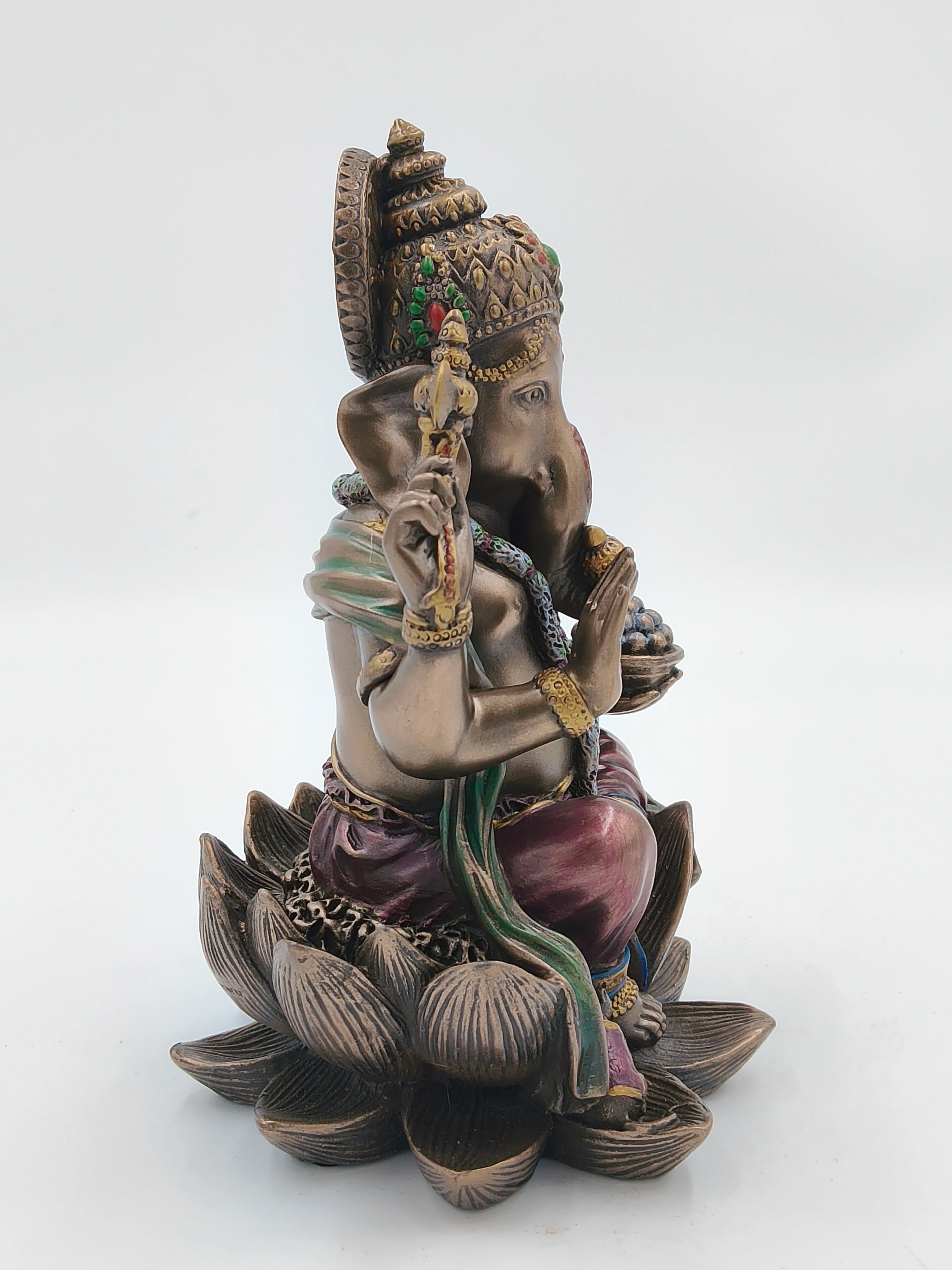 Polyresin Ganesh statue seated on a lotus with decorative attire and ornaments side view