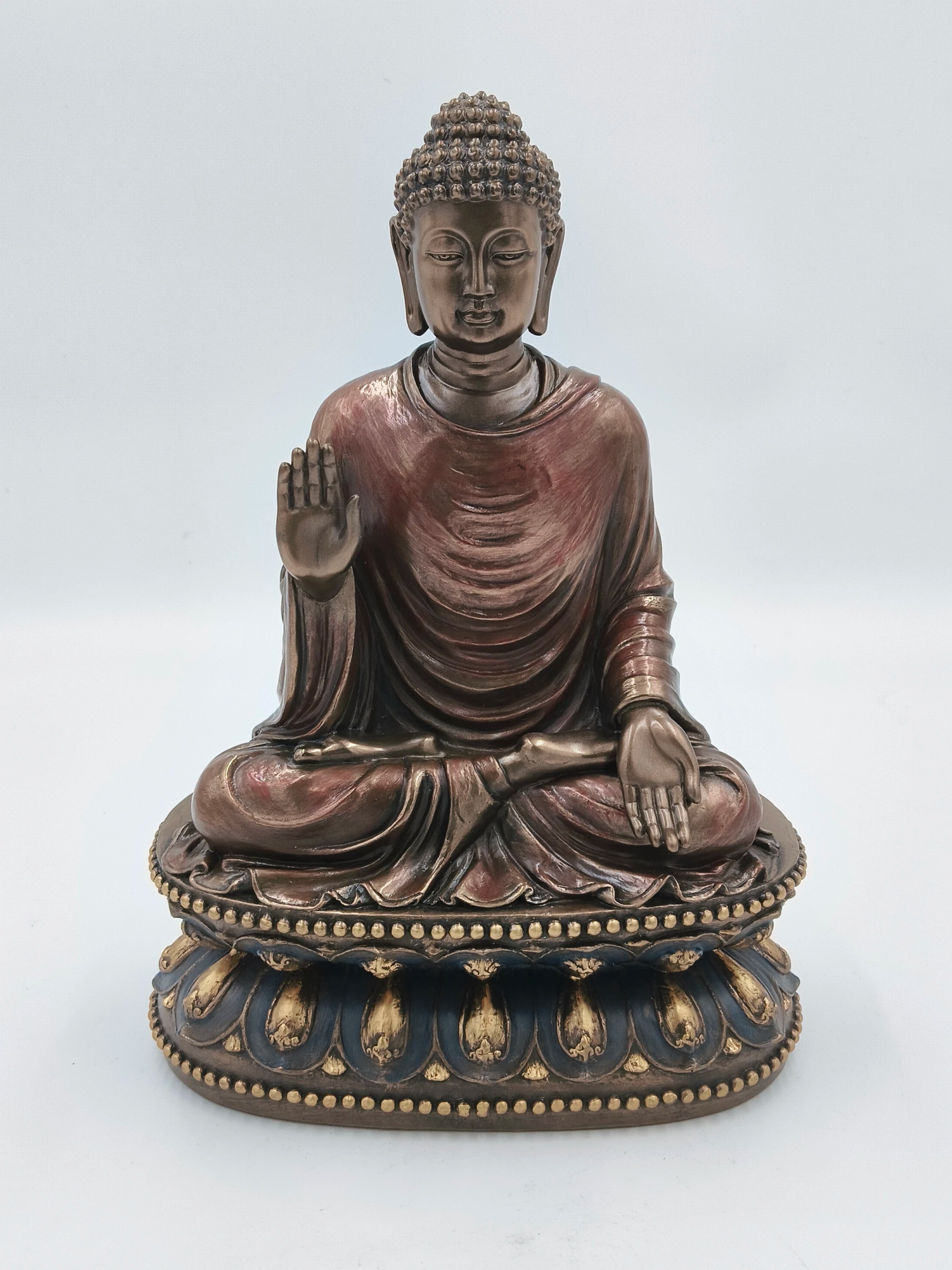 Large polyresin Buddha sculpture seated on ornate base with raised hand