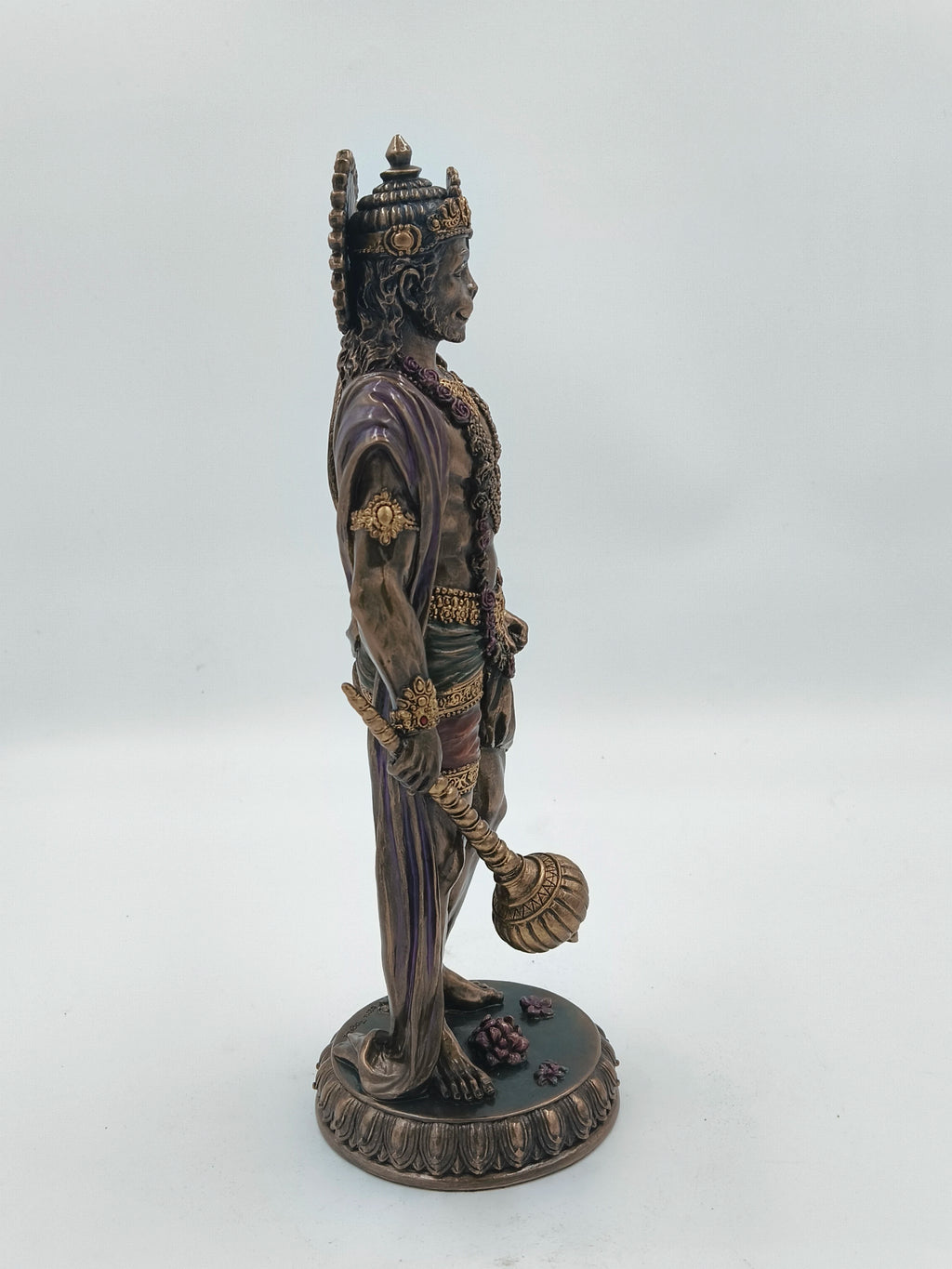 Side view of large polyresin Hanuman standing sculpture holding mace