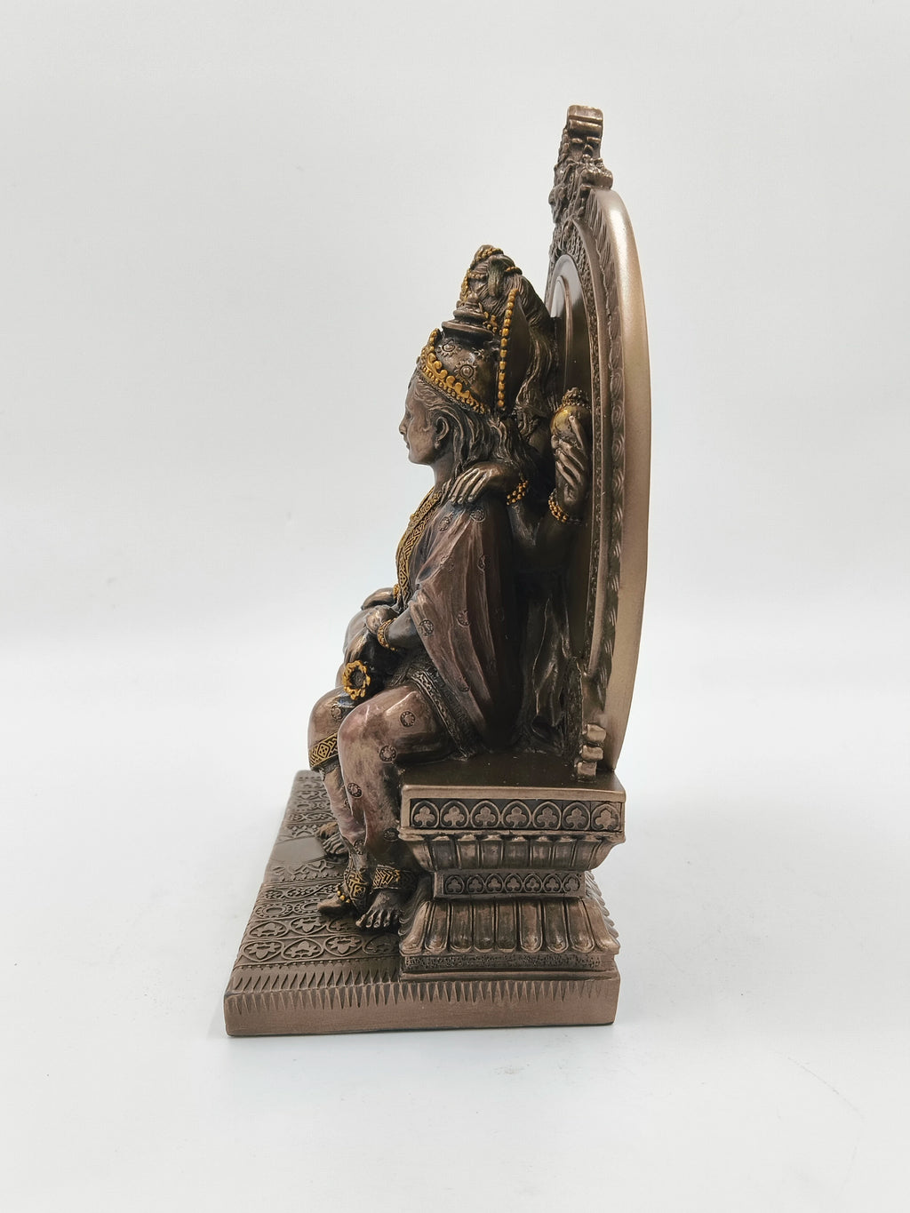 Side view of polyresin large sculpture of Shiva family seated on intricately carved sinhasan