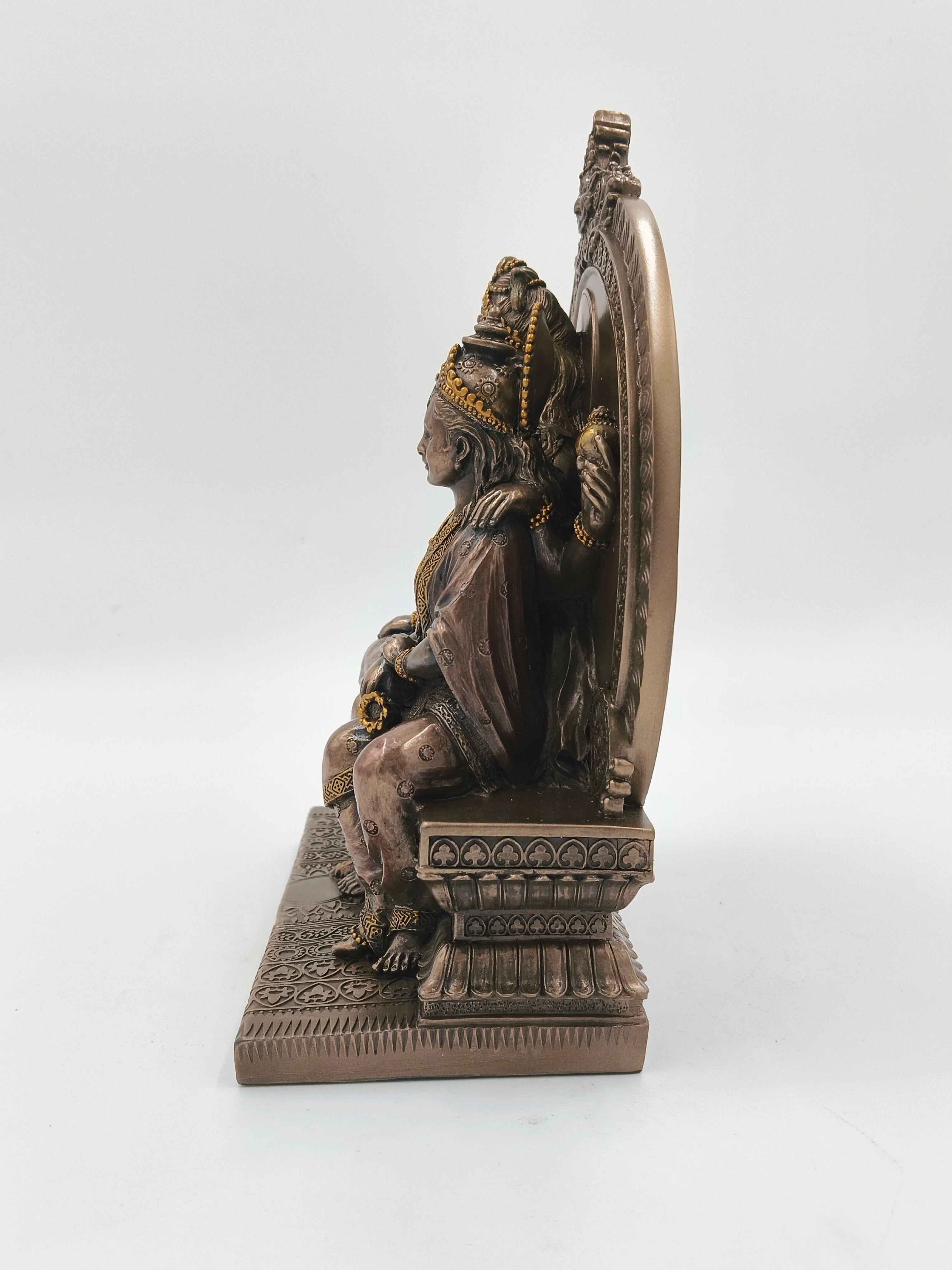 Side view of polyresin large sculpture of Shiva family seated on intricately carved sinhasan