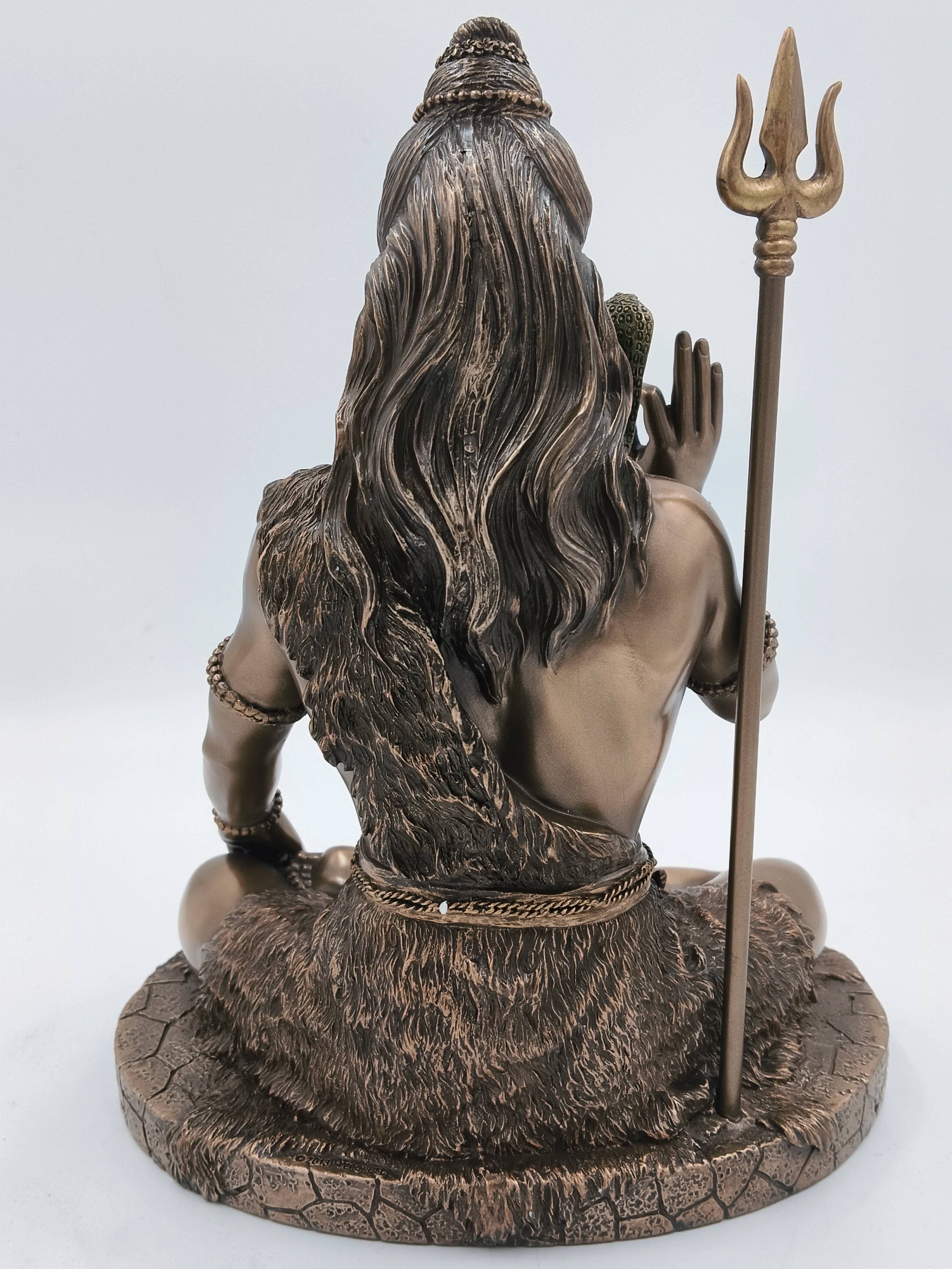 Back view of large polyresin sitting Shiva statue holding trident