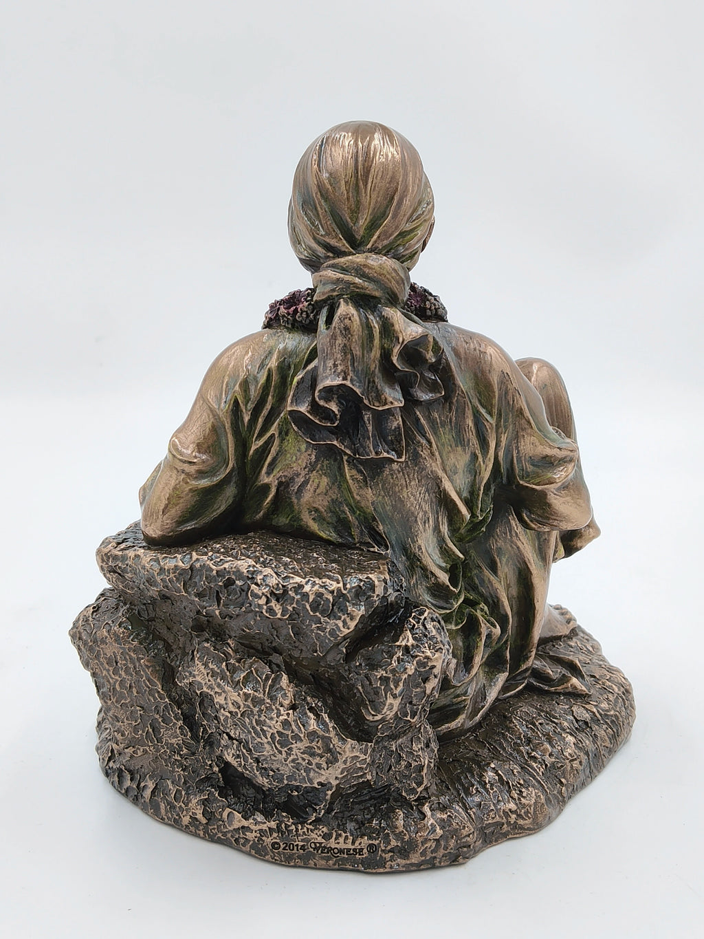 Back view of large polyresin Shirdi Sai Baba statue seated on textured base