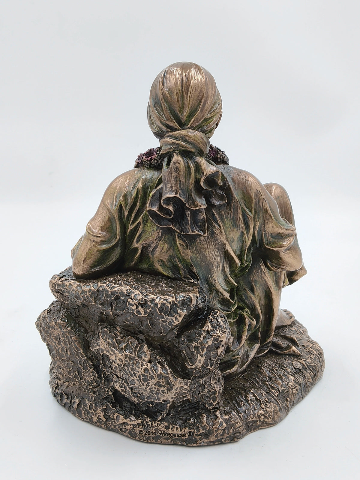 Back view of large polyresin Shirdi Sai Baba statue seated on textured base