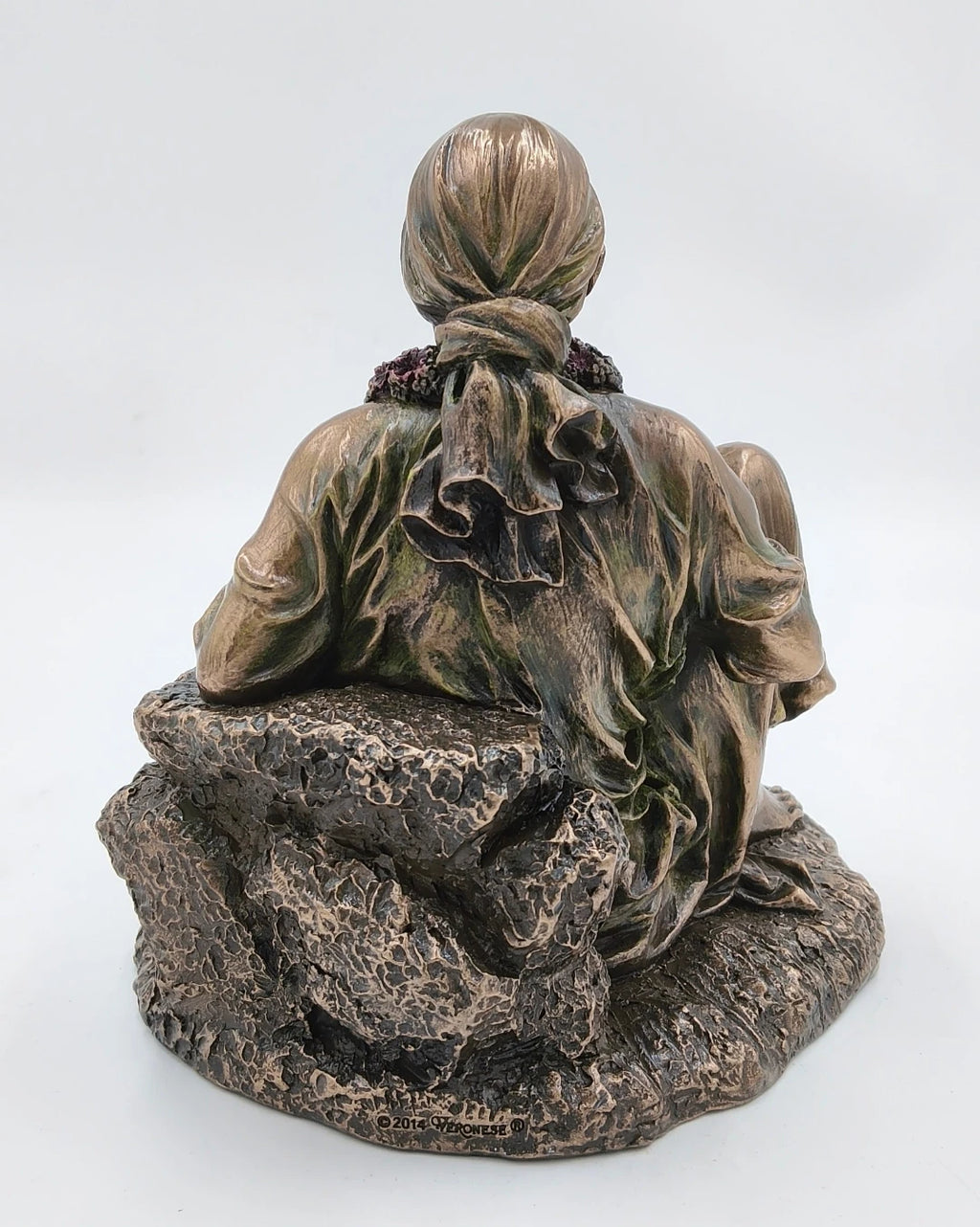 Back view of large polyresin Shirdi Sai Baba statue seated on textured base