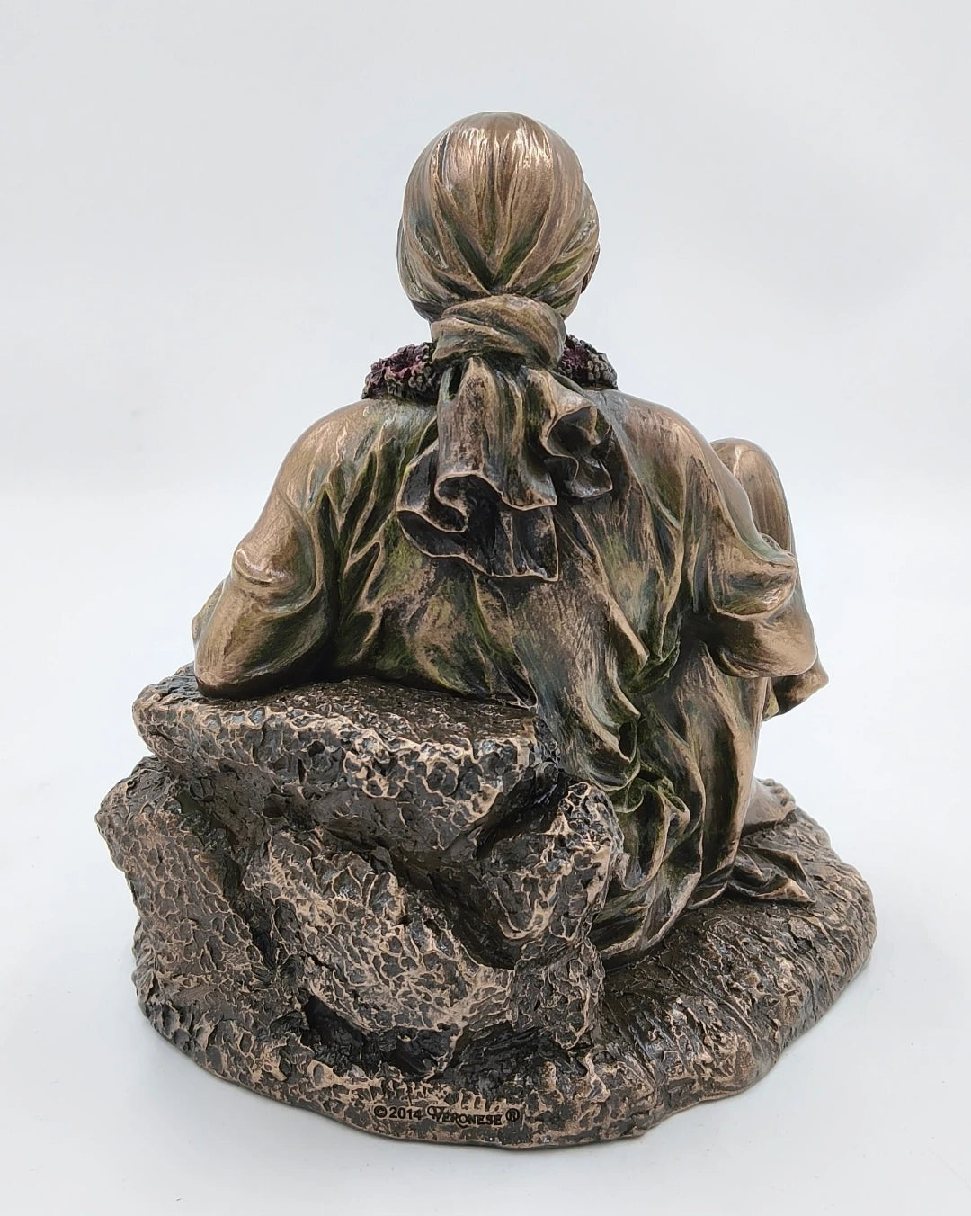 Back view of large polyresin Shirdi Sai Baba statue seated on textured base