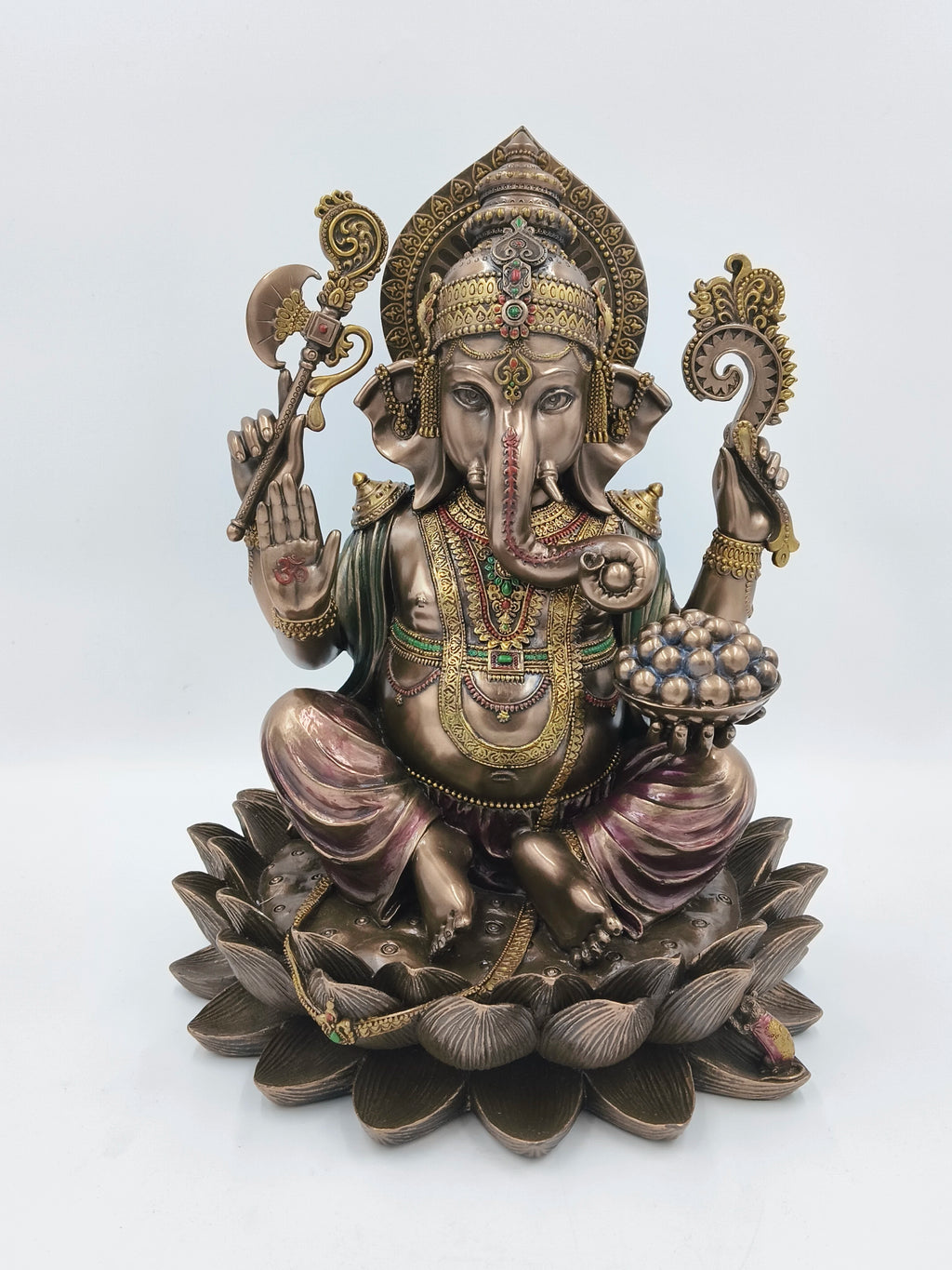 Front view of large polyresin Ganesh statue seated on a lotus with intricate details