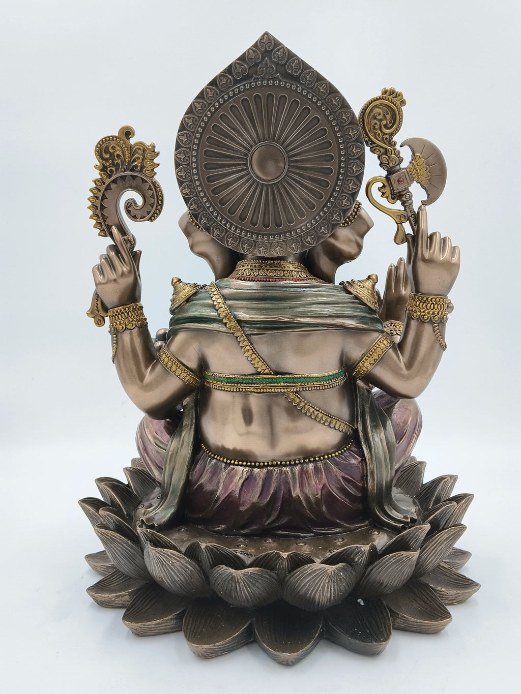 Back view of a large polyresin Ganesh sculpture seated on a lotus base