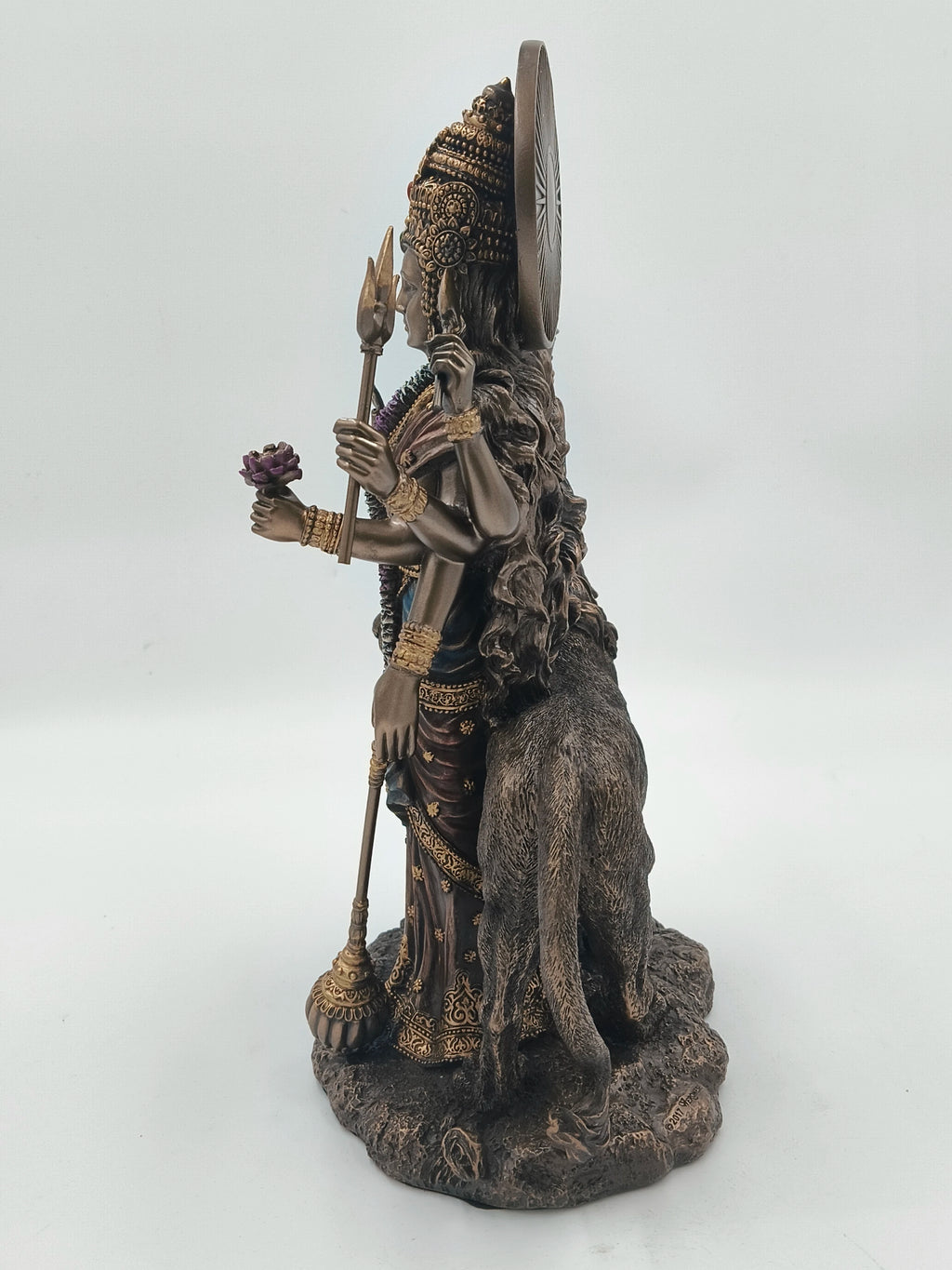 Side view of large polyresin sculpture of Hindu goddess Durga with lion