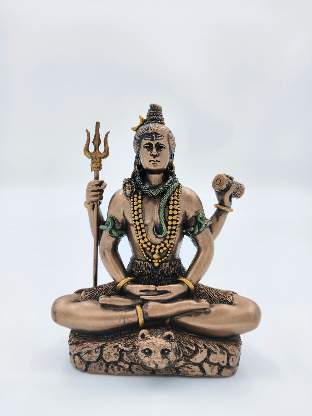 Small polyresin Shiva statue seated in meditation with trident and drum